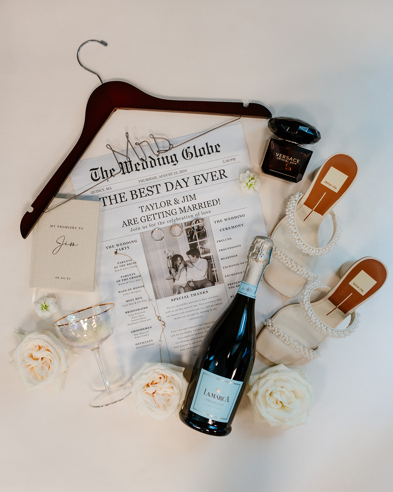 A bottle of champagne, a newspaper, a hanger that says mrs, bridal shoes and perfume
