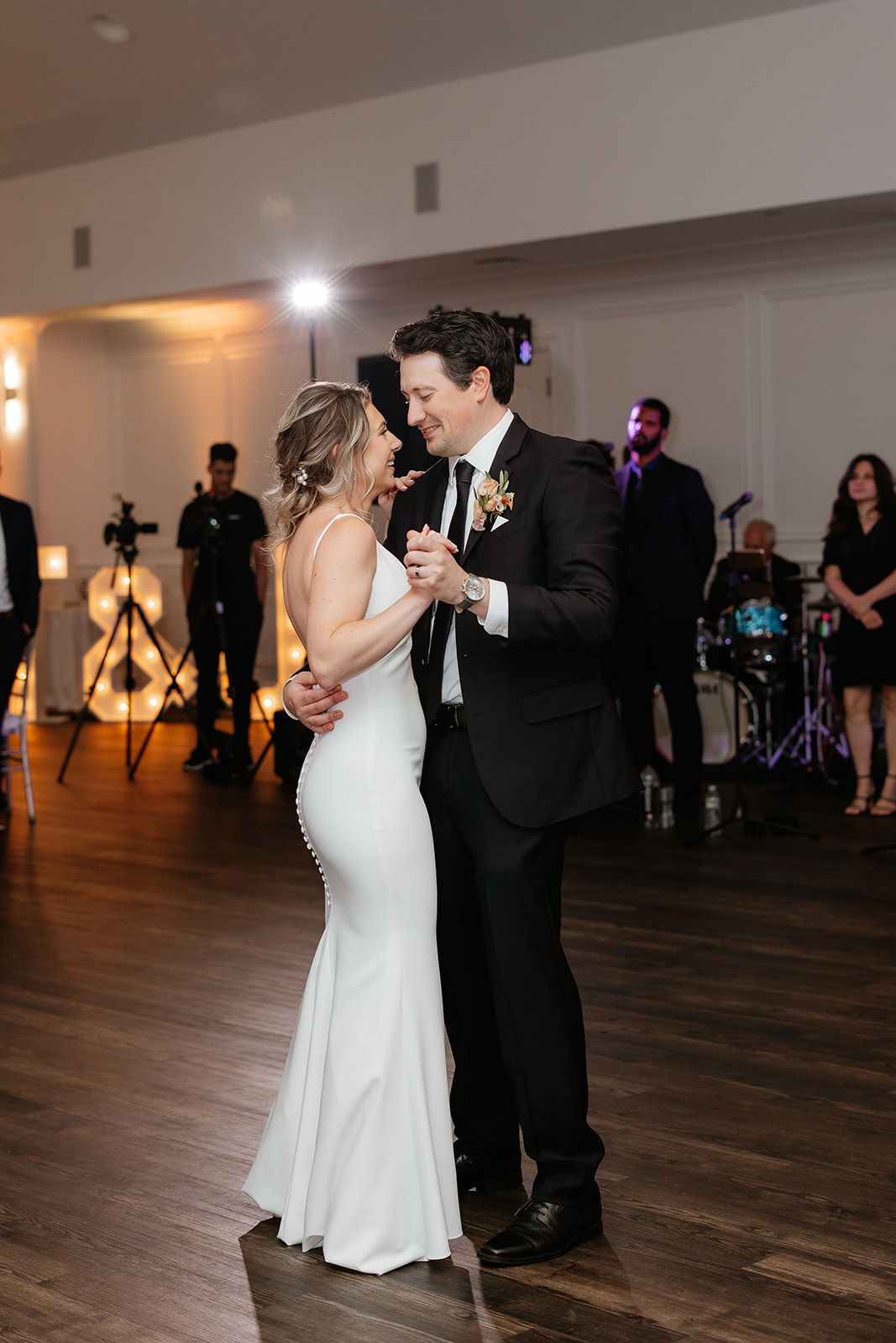 A joyful bride and groom dancing together at their wedding reception, celebrating their special day with love and happiness.