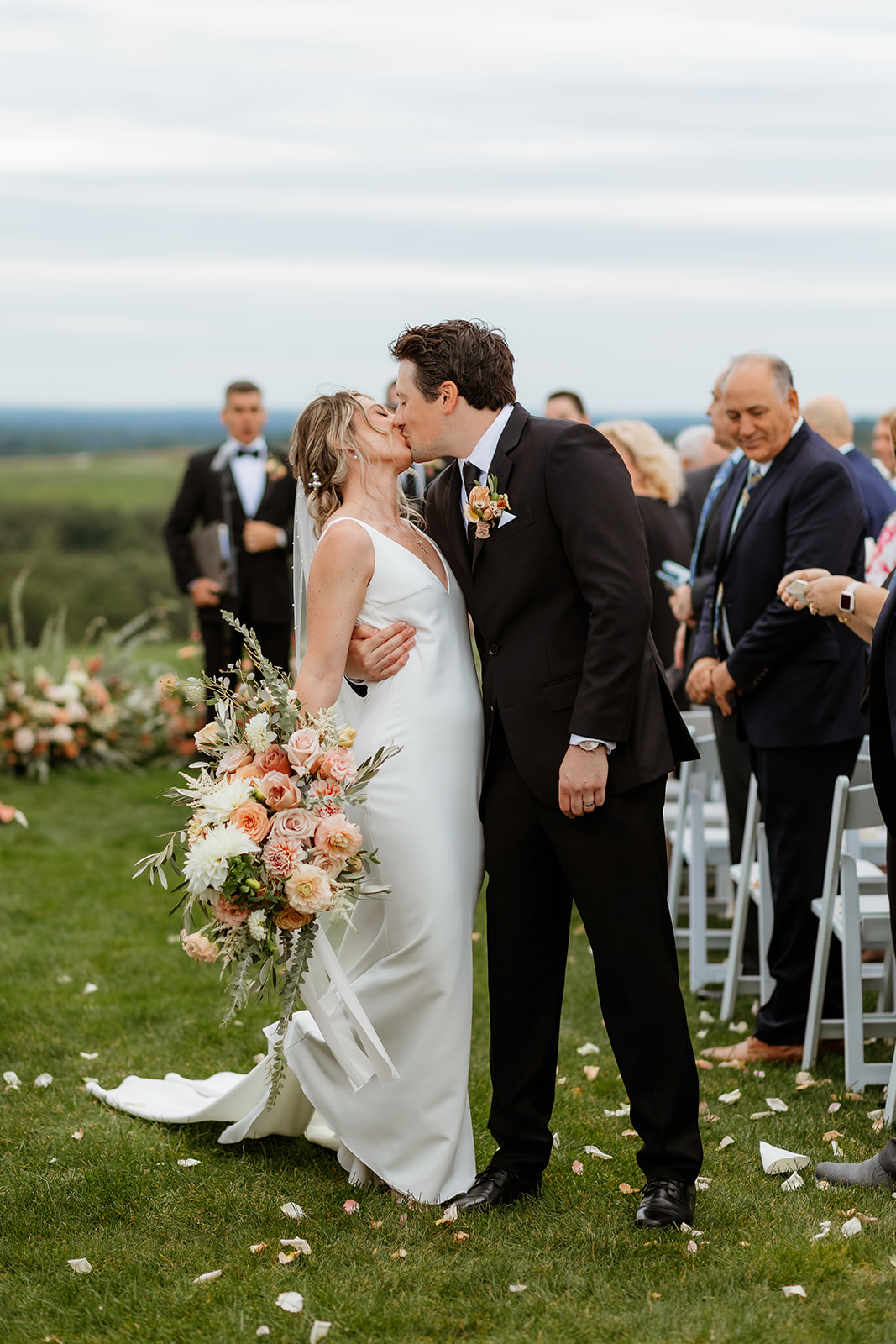 A bride and groom kissing while exiting their wedding ceremony at Granite Links