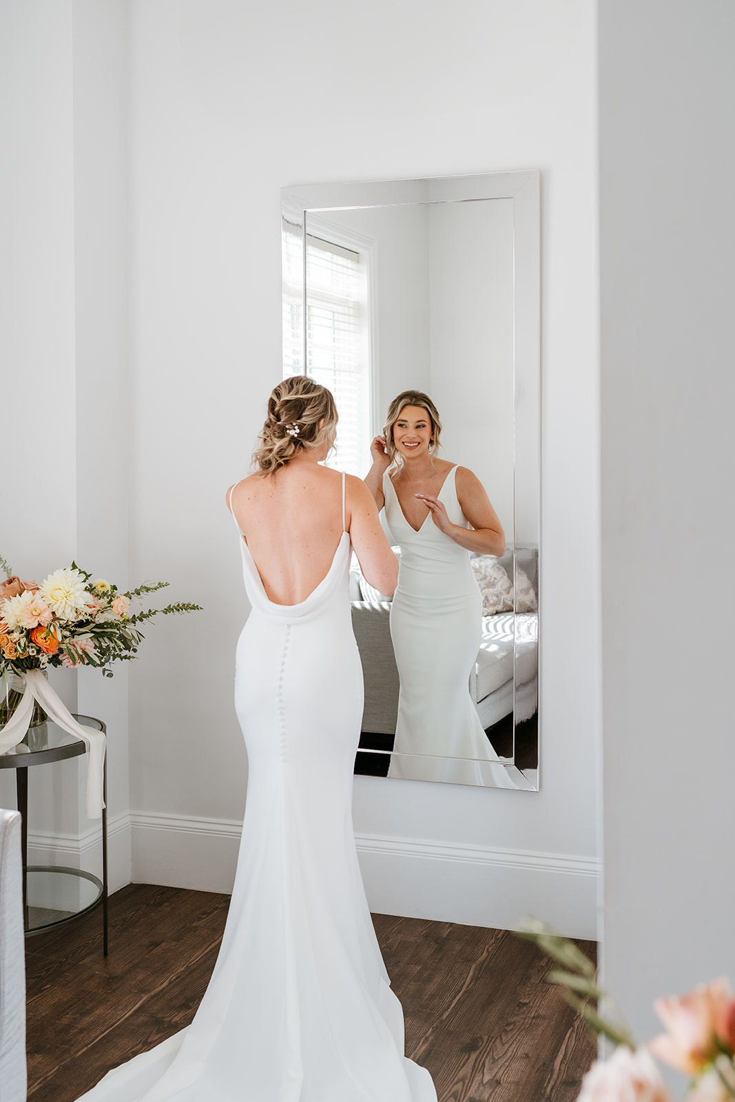 Bride getting ready and looking into the mirror
