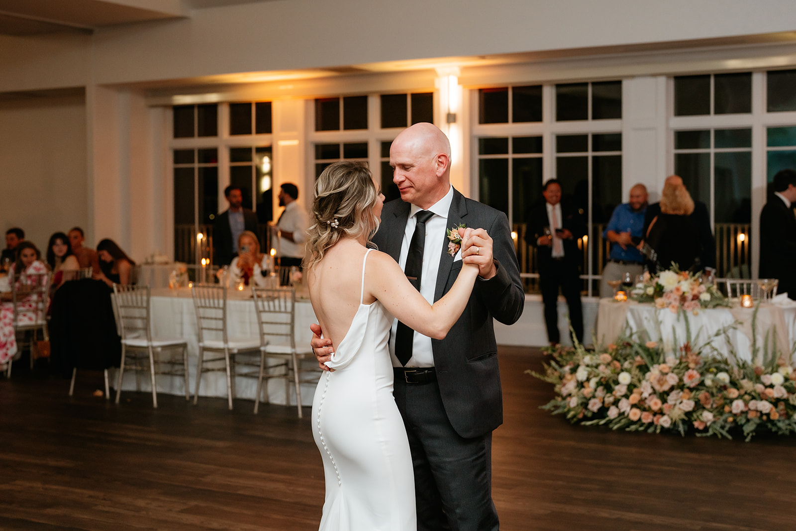 A joyful bride and dad dancing together at their wedding reception at Granite Links celebrating their special day with love and happiness.