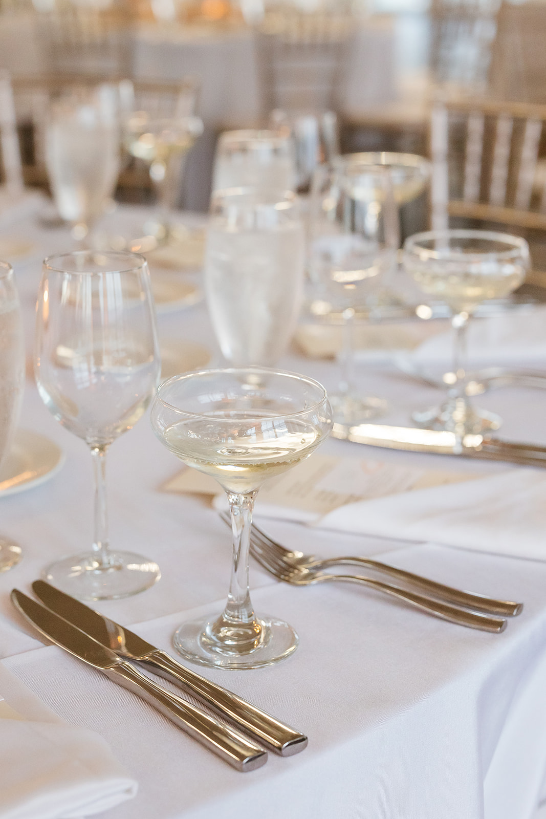 A table set with a white tablecloth and silverware, ready for a formal dining experience.