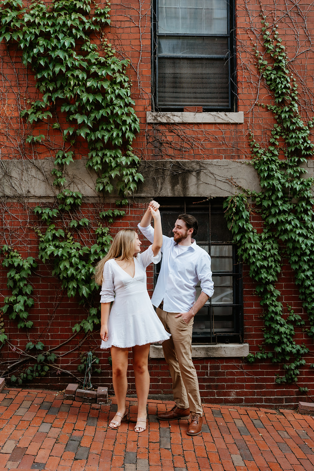 Couple dancing on the cobblestone streets of Beacon Hill for their Beacon Hill couples session