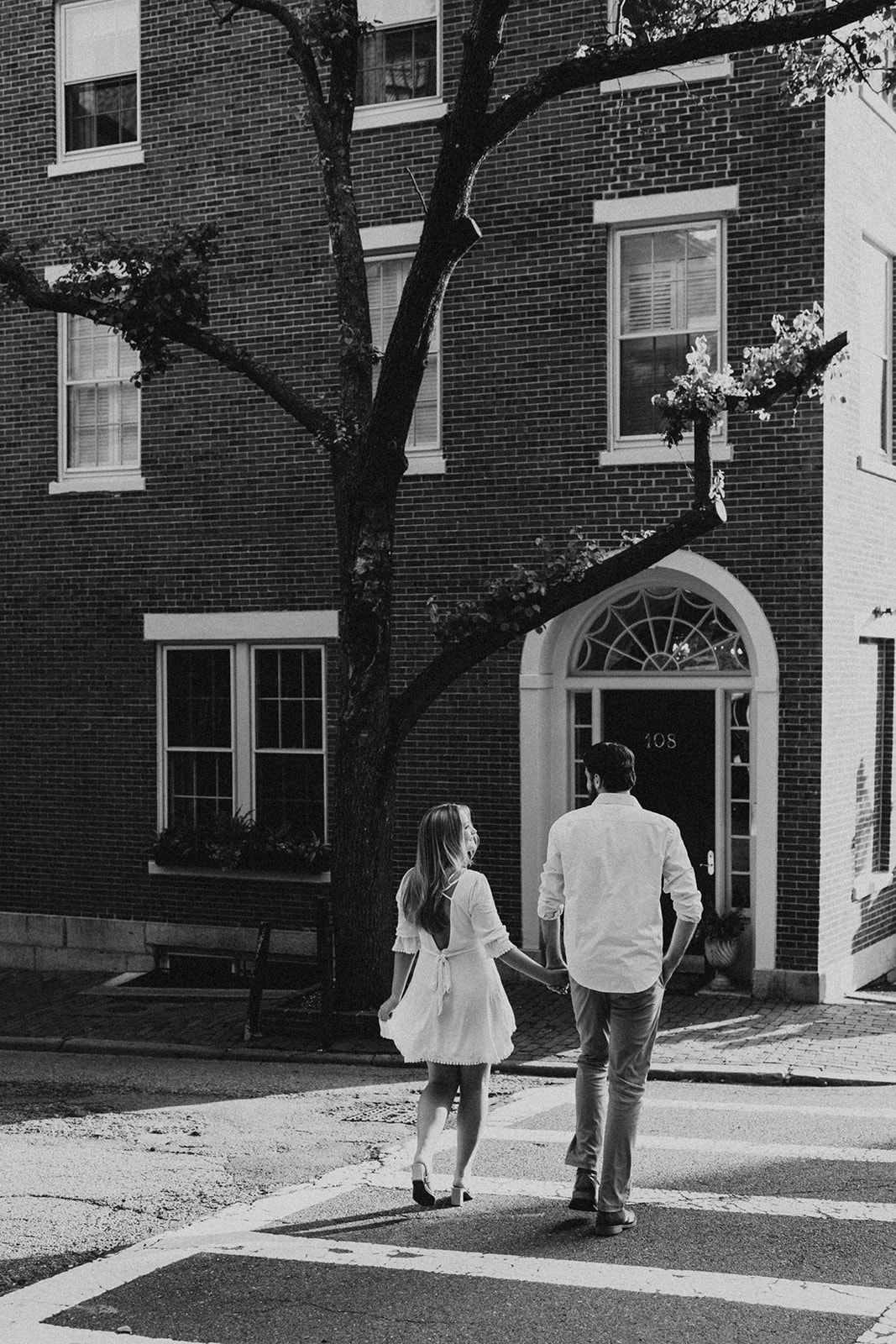 Black and white photo of couple walking the streets of Beacon Hill