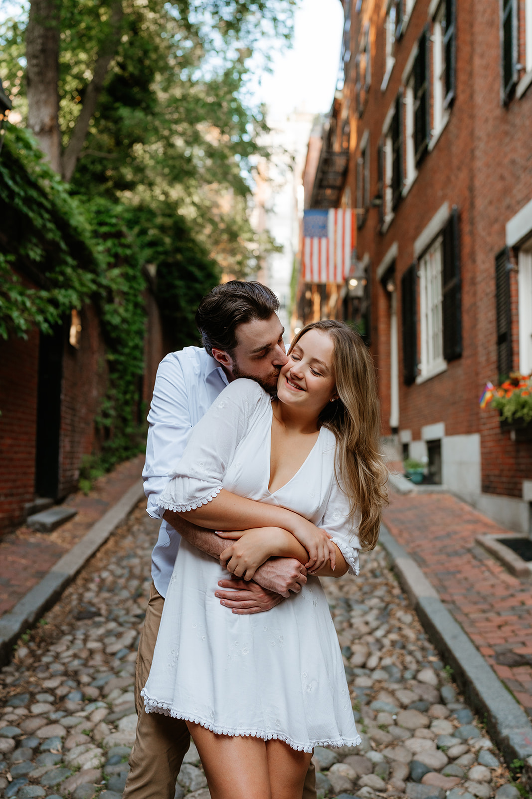 Couple hugging one another smiling at Acorn Street for their Beacon Hills couple session