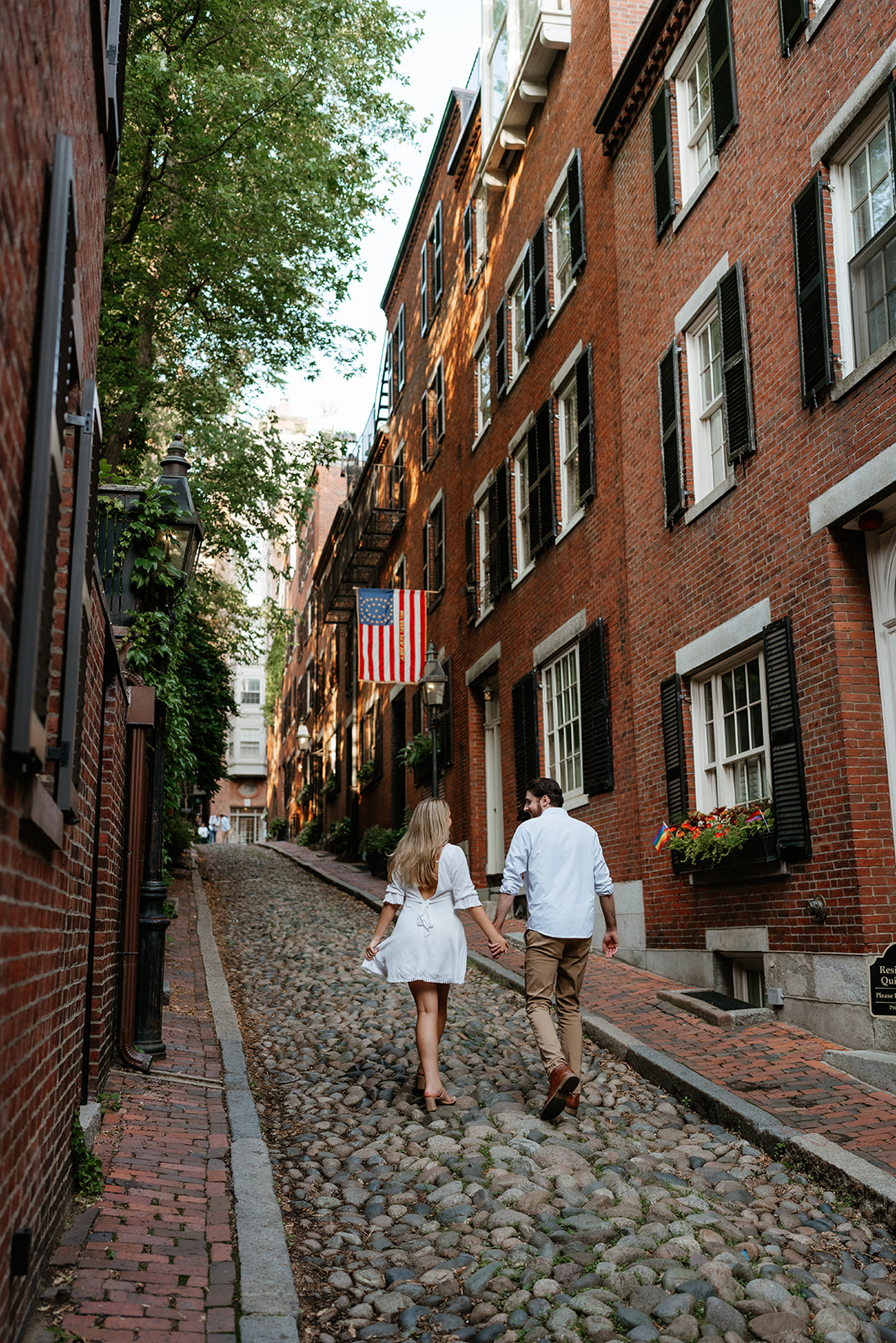 Couple walking down Acorn street in Boston for their Beacon Hill couples session