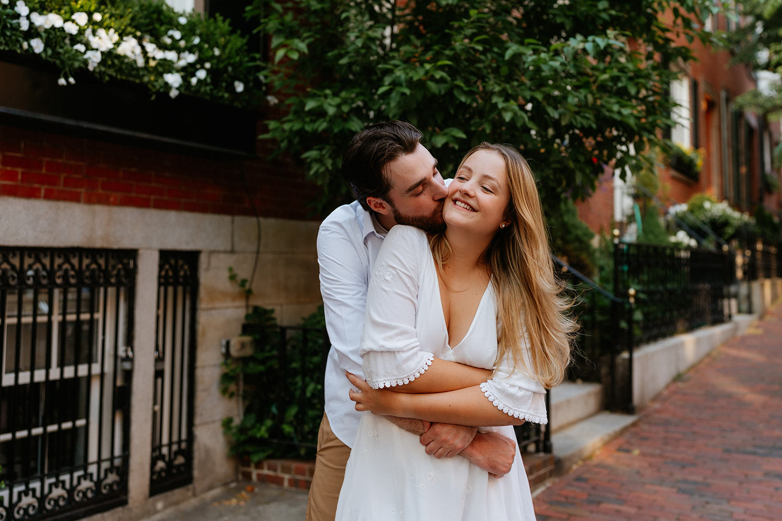 Boyfriend kissing girlfriends cheek during their Beacon Hill couples session