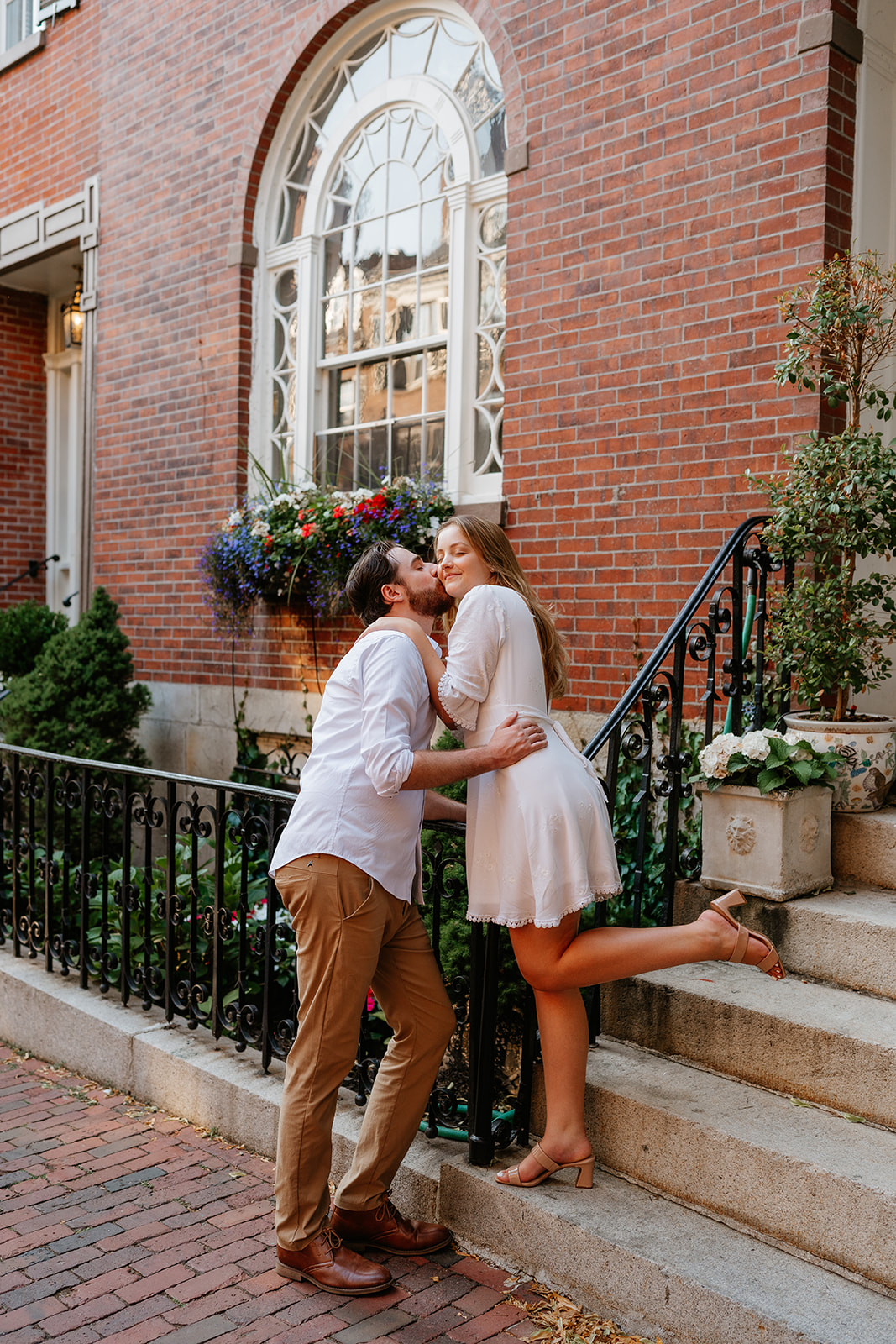 Boyfriend kissing girlfriends cheek during their Beacon Hill couples session