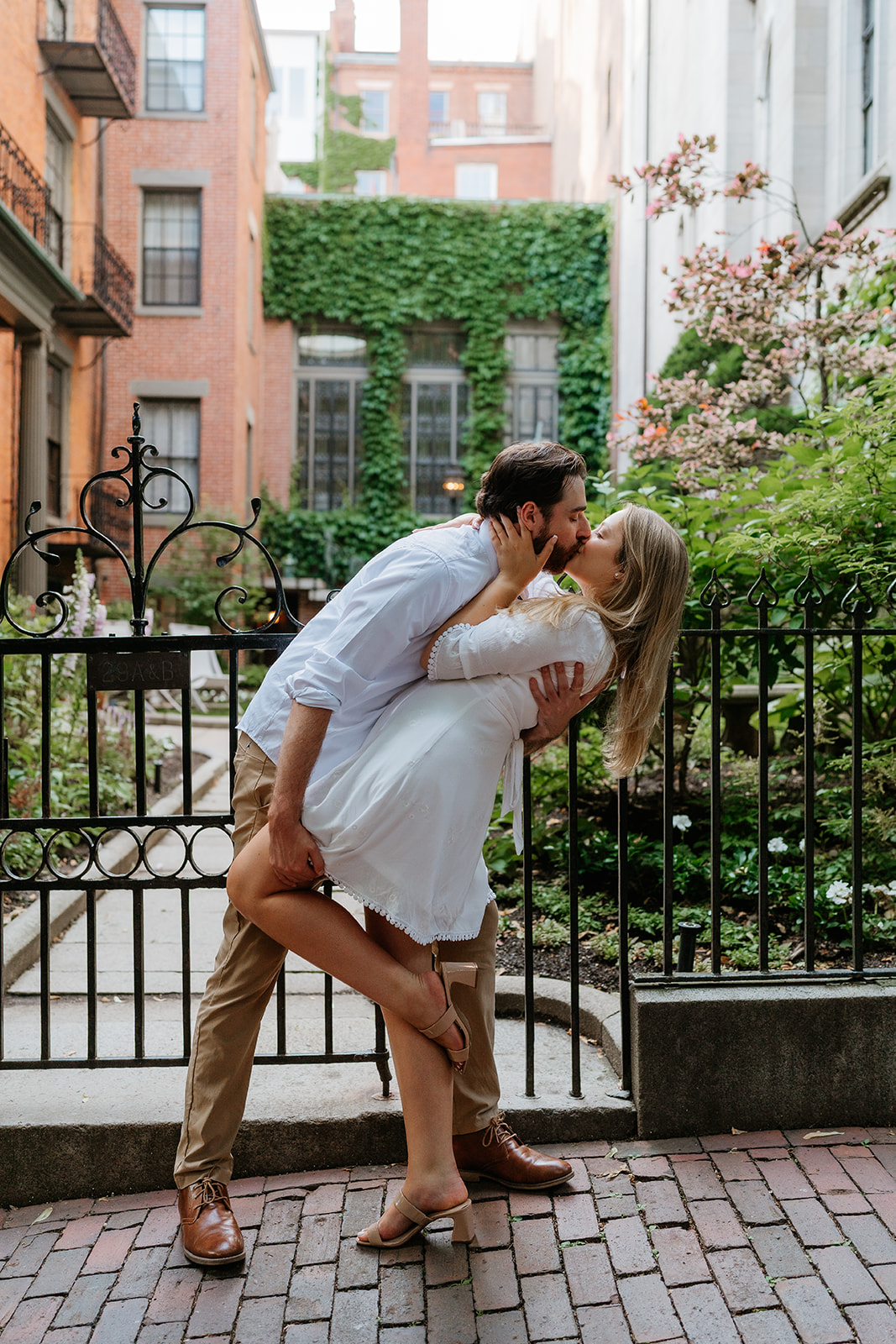 Couple kissing on the streets of Beacon hill for their beacon hill couple session