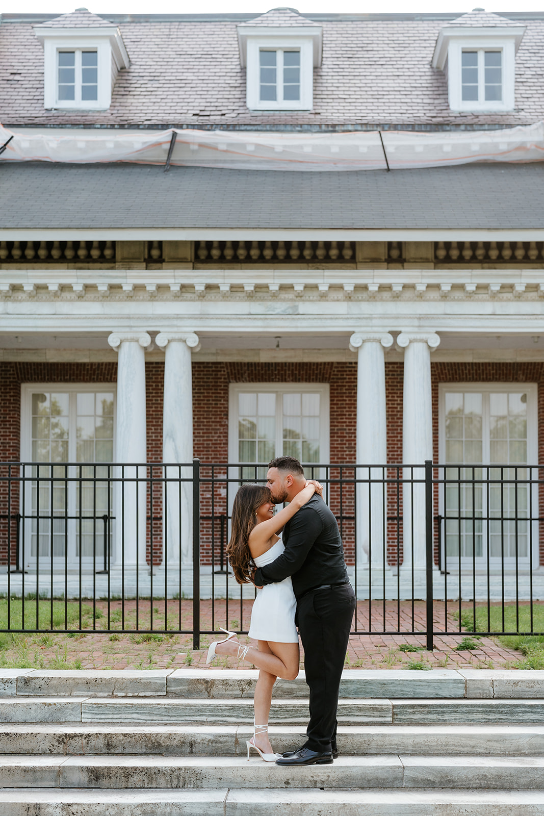 A man and woman at The Garden at Elm Bank during their engagement session