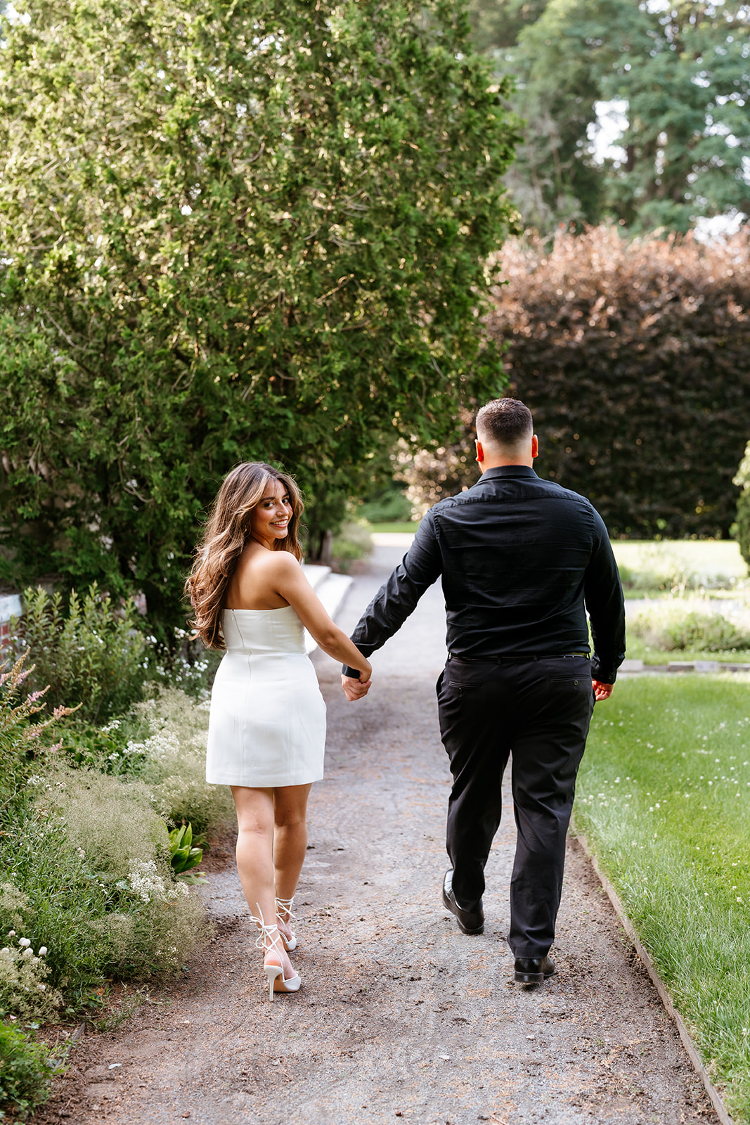 A man and woman at The Garden at Elm Bank during their engagement session