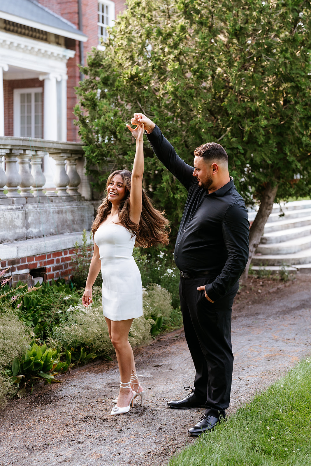 A man and woman at The Garden at Elm Bank during their engagement session