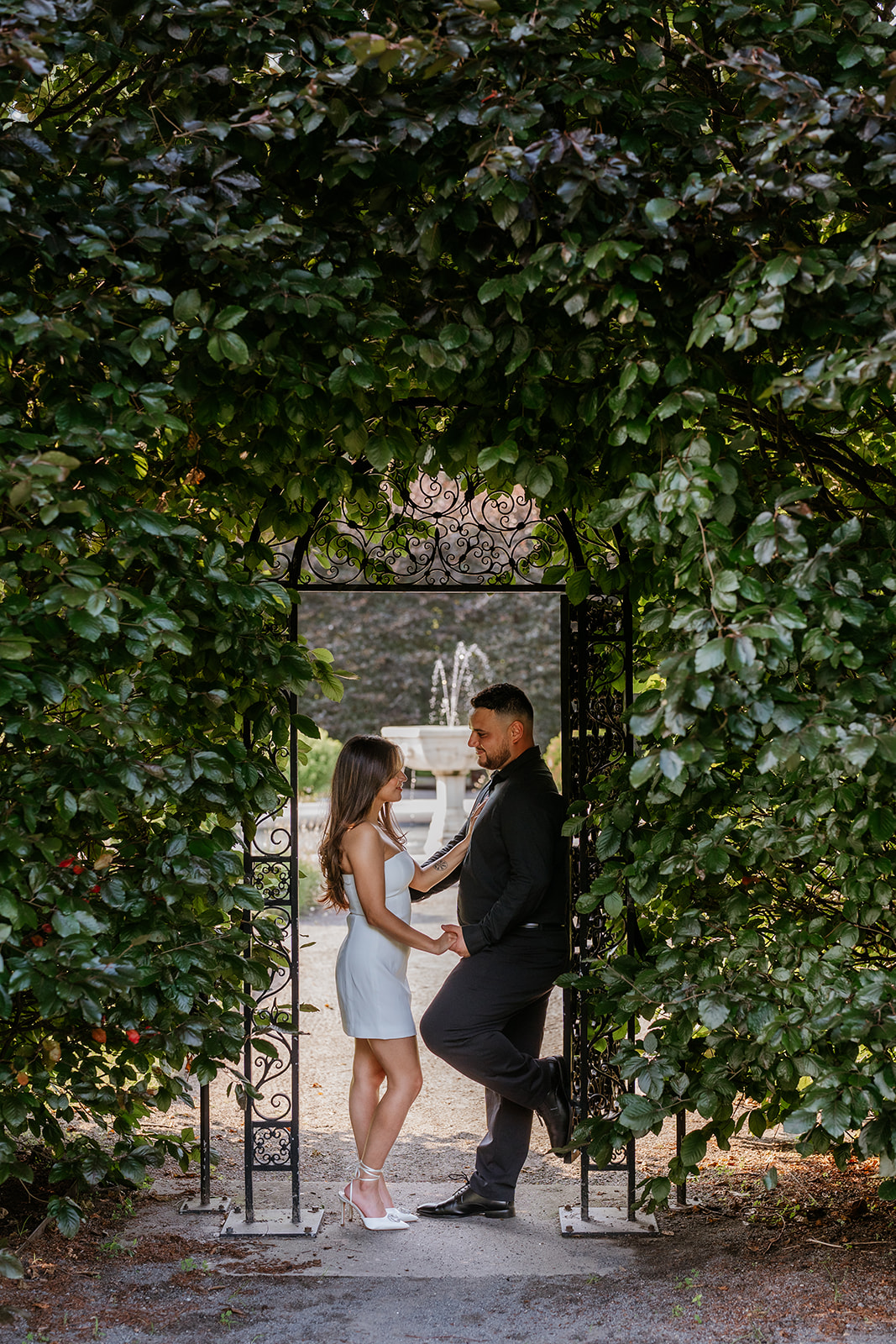 A man and woman at The Garden at Elm Bank during their engagement session