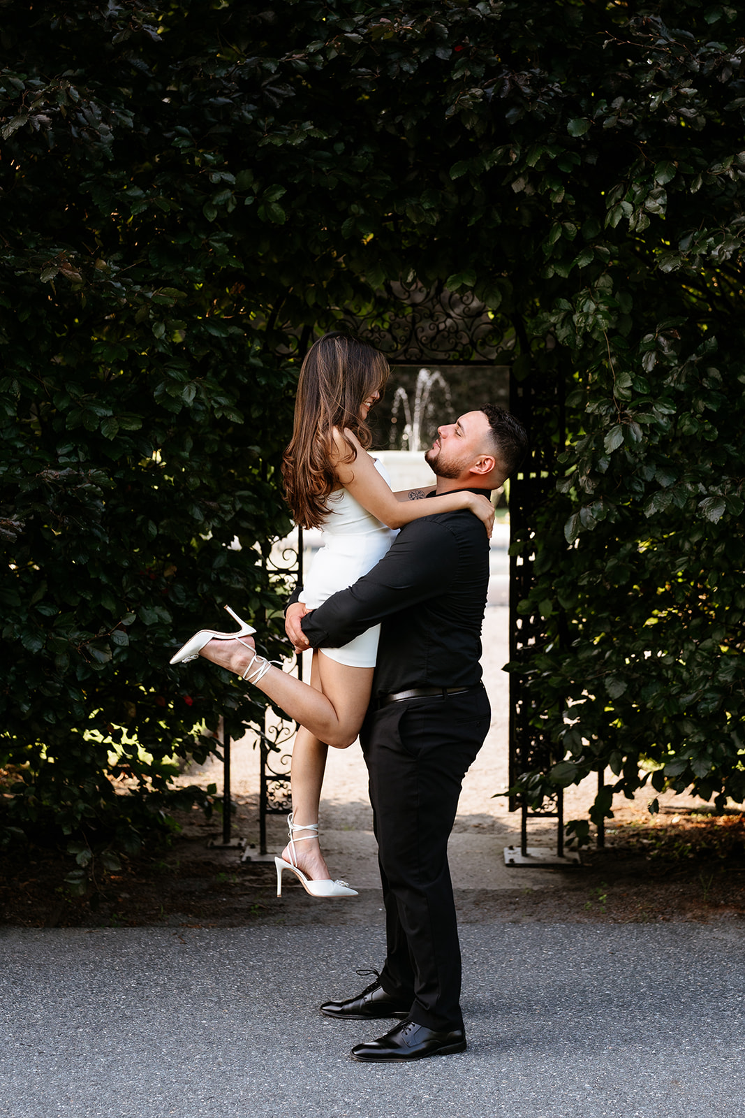 A man and woman at The Garden at Elm Bank during their engagement session