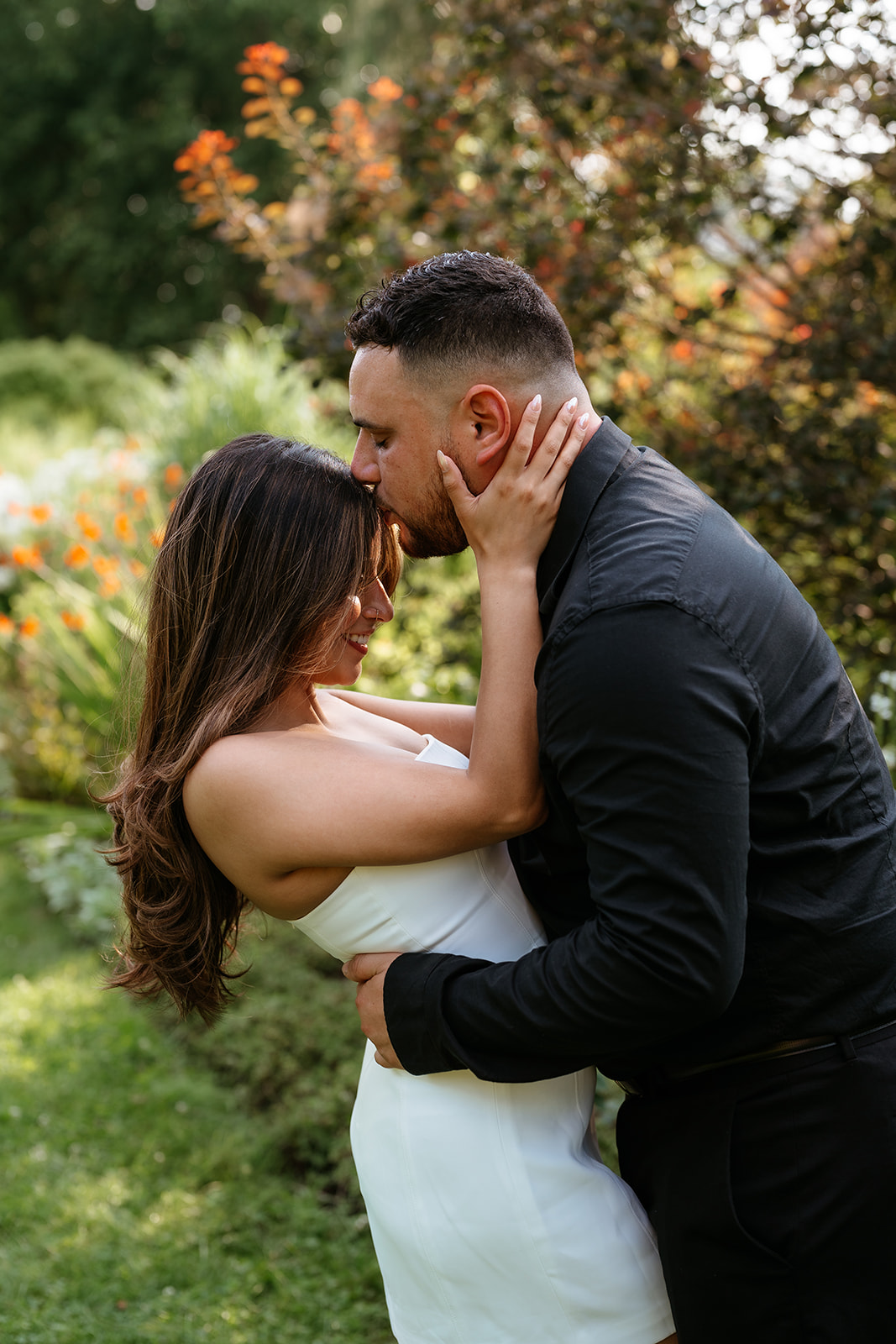 A man and woman at The Garden at Elm Bank during their engagement session