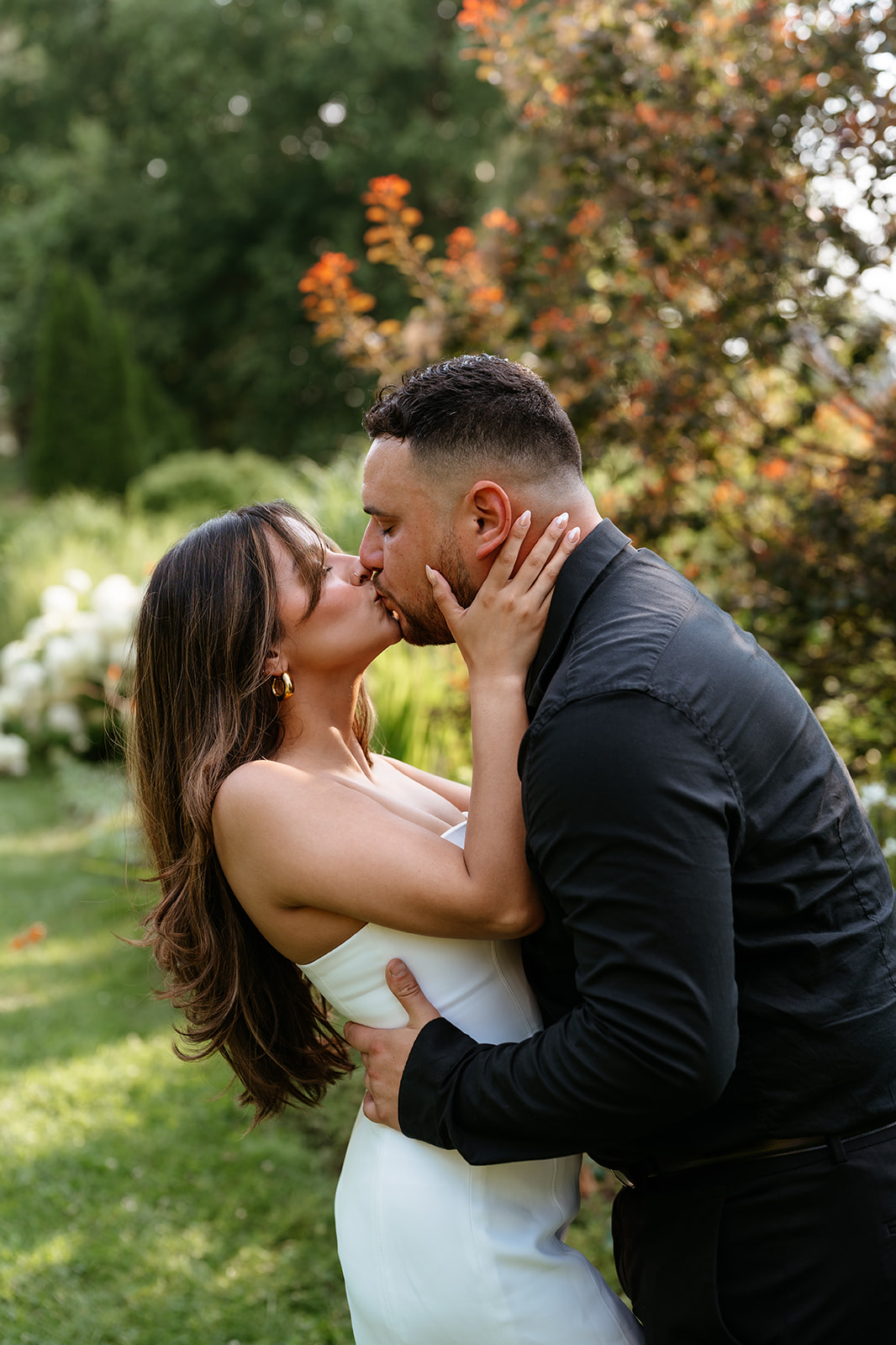 A man and woman at The Garden at Elm Bank during their engagement session