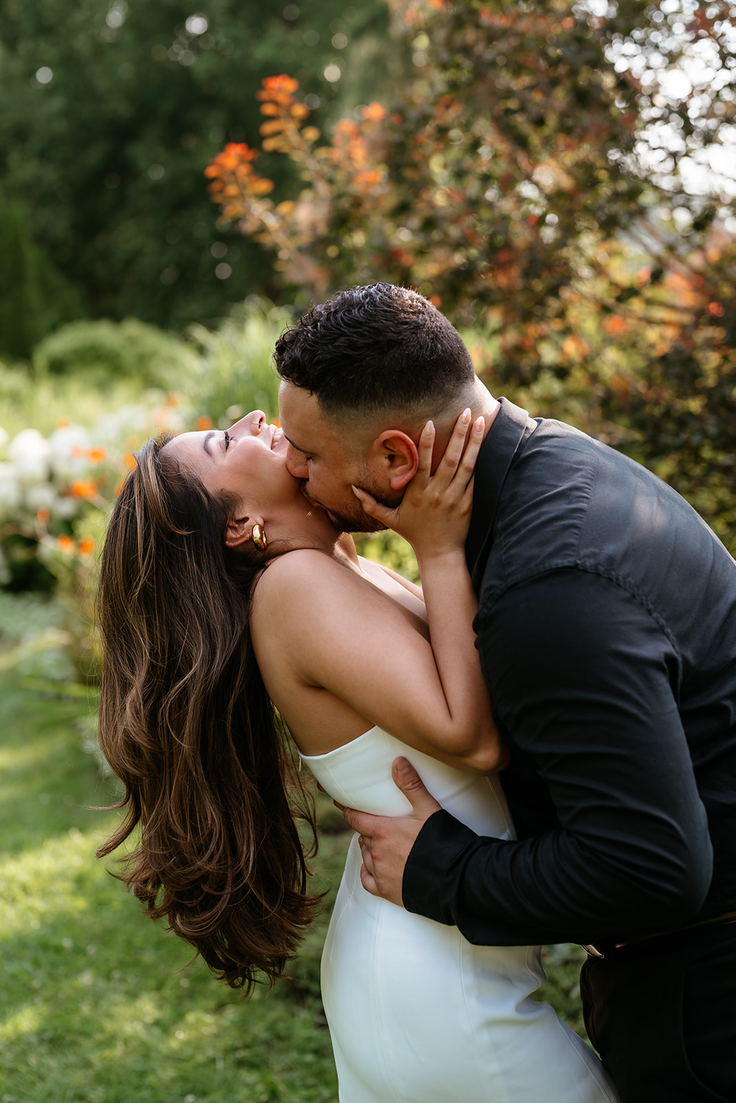 A man and woman at The Garden at Elm Bank during their engagement session