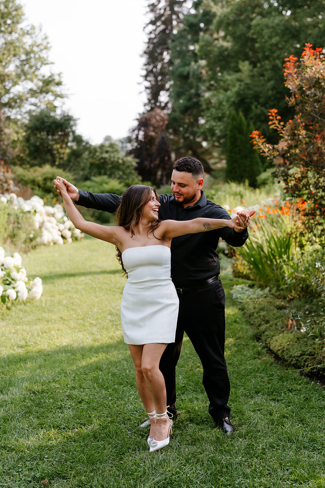 A man and woman at The Garden at Elm Bank during their engagement session