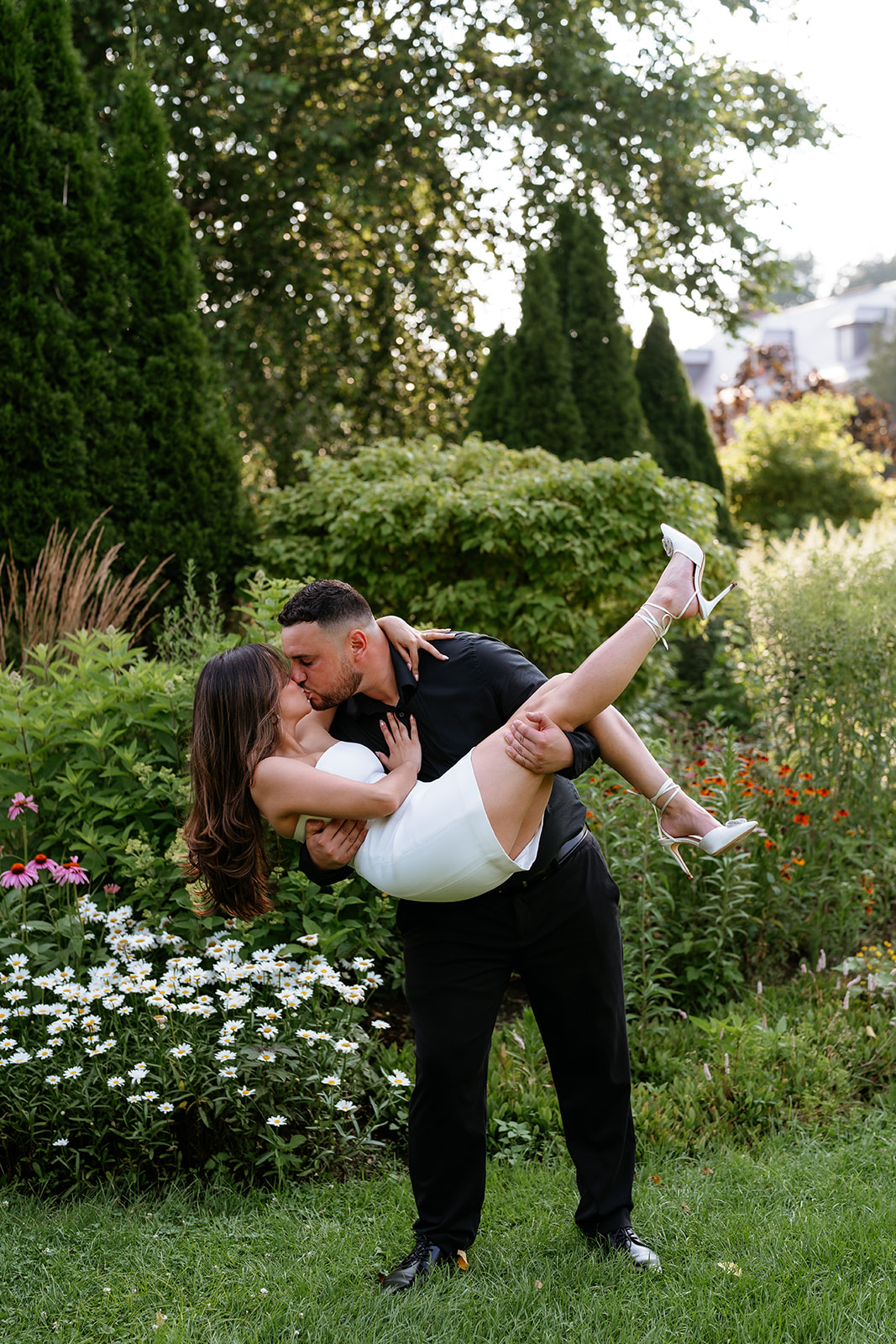 A man and woman at The Garden at Elm Bank during their engagement session