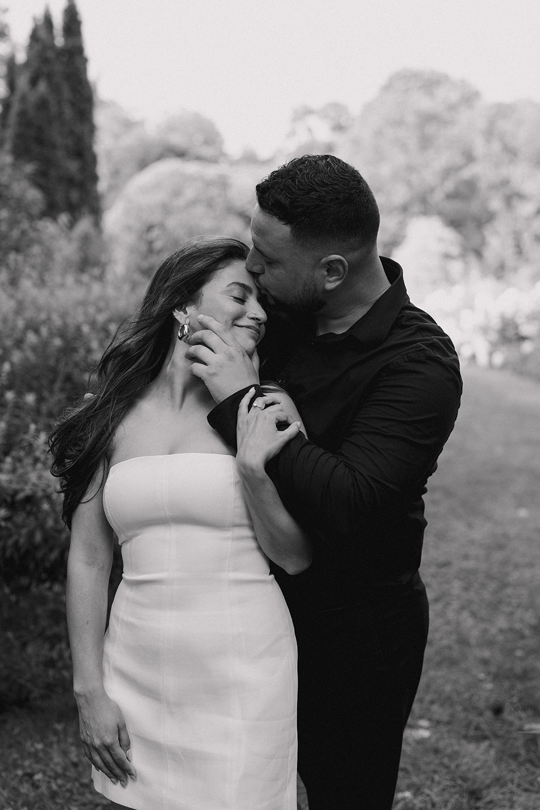 A man and woman at The Garden at Elm Bank during their engagement session