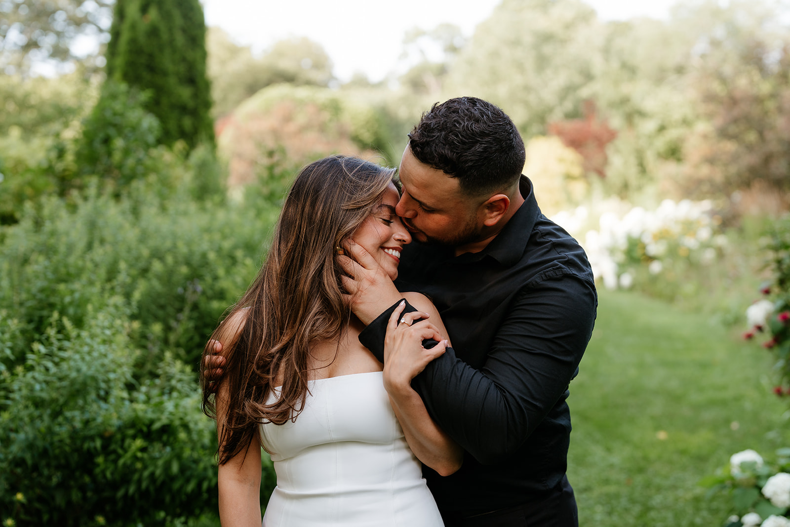 A man and woman at The Garden at Elm Bank during their engagement session