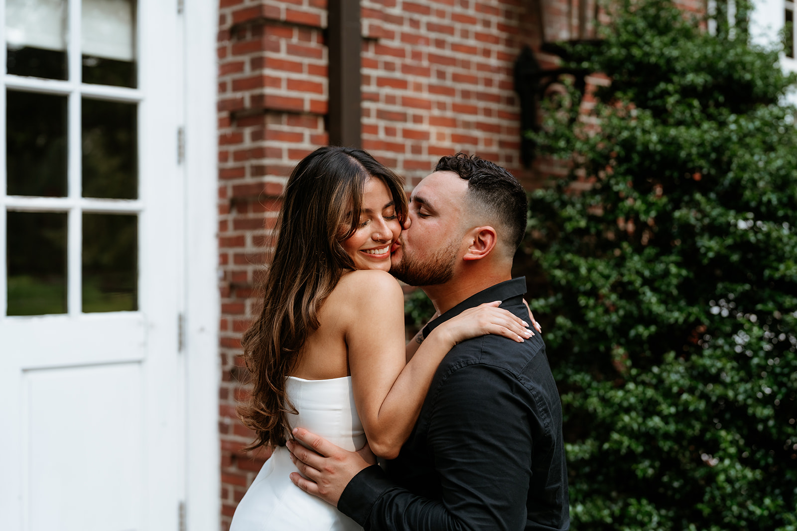 A man and woman at The Garden at Elm Bank during their engagement session