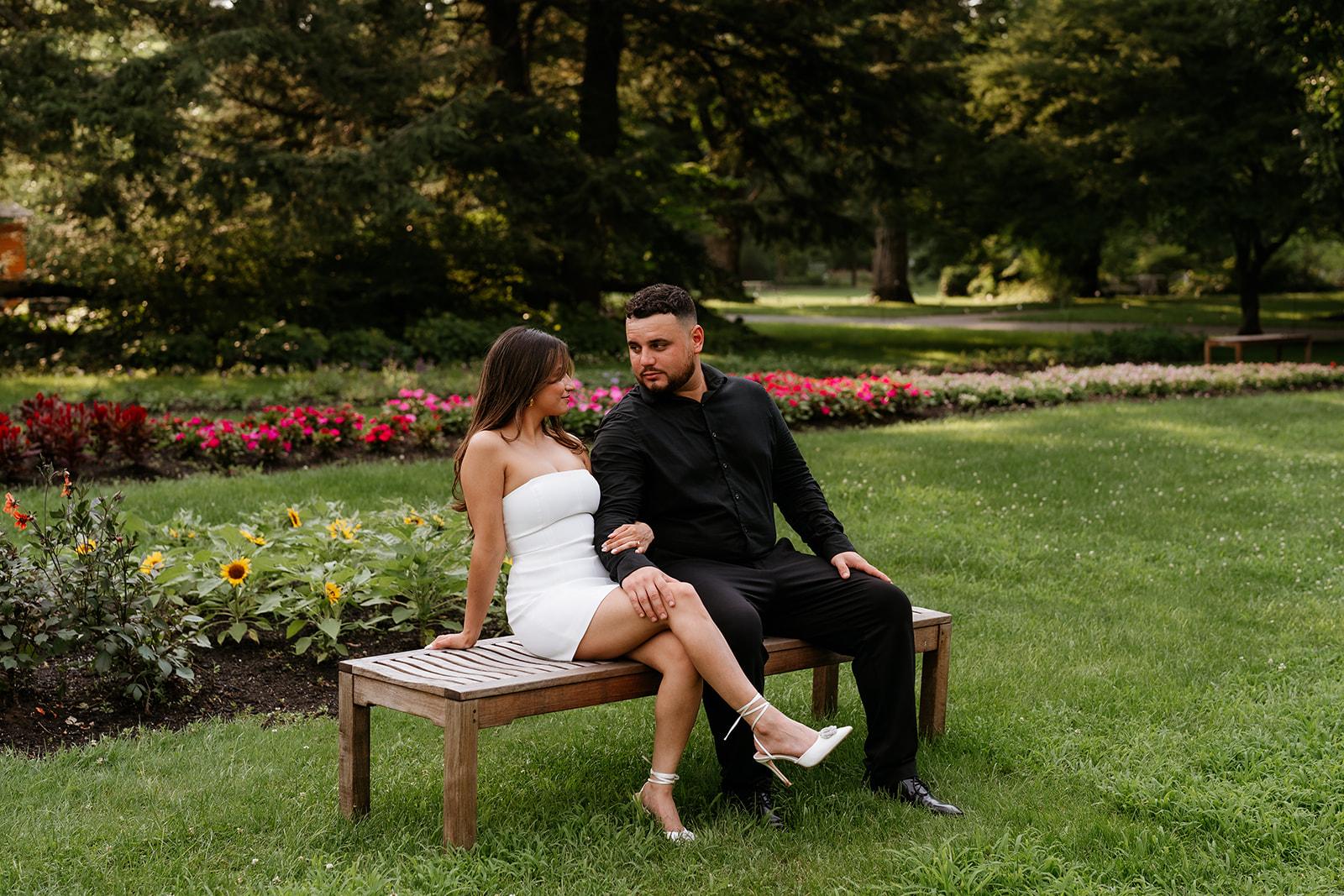 A man and woman at The Garden at Elm Bank holding hands during their engagement session