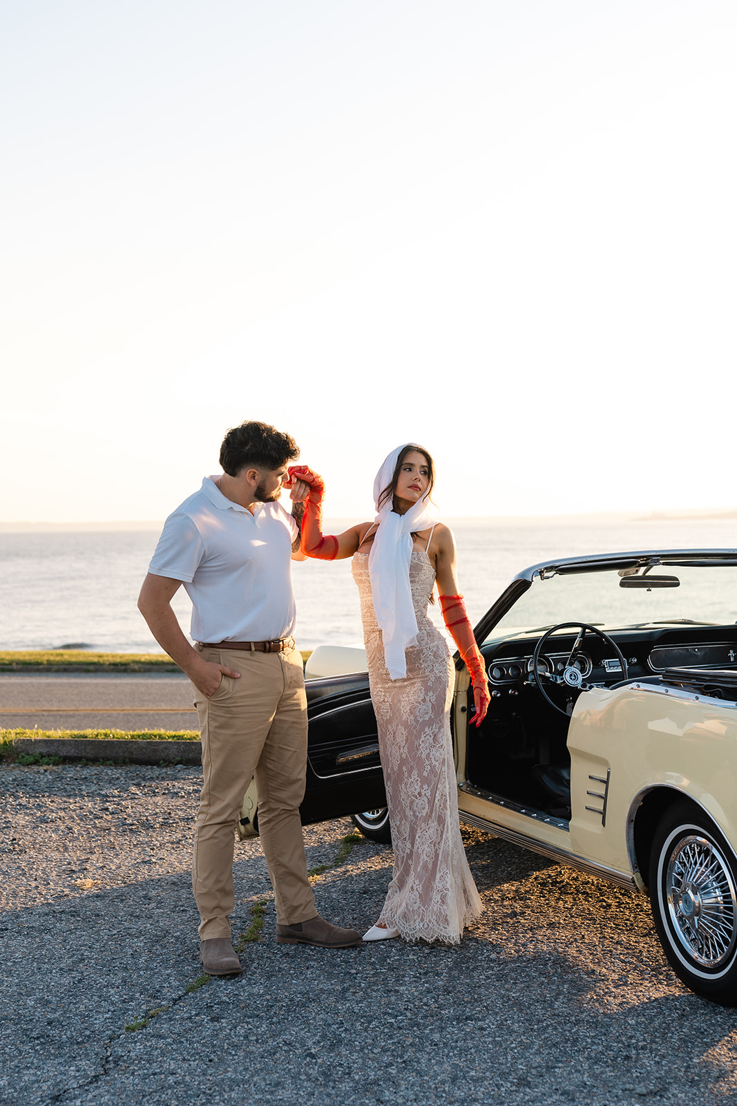 Newly engaged couple posing in a vintage car for their classic car engagement photos 