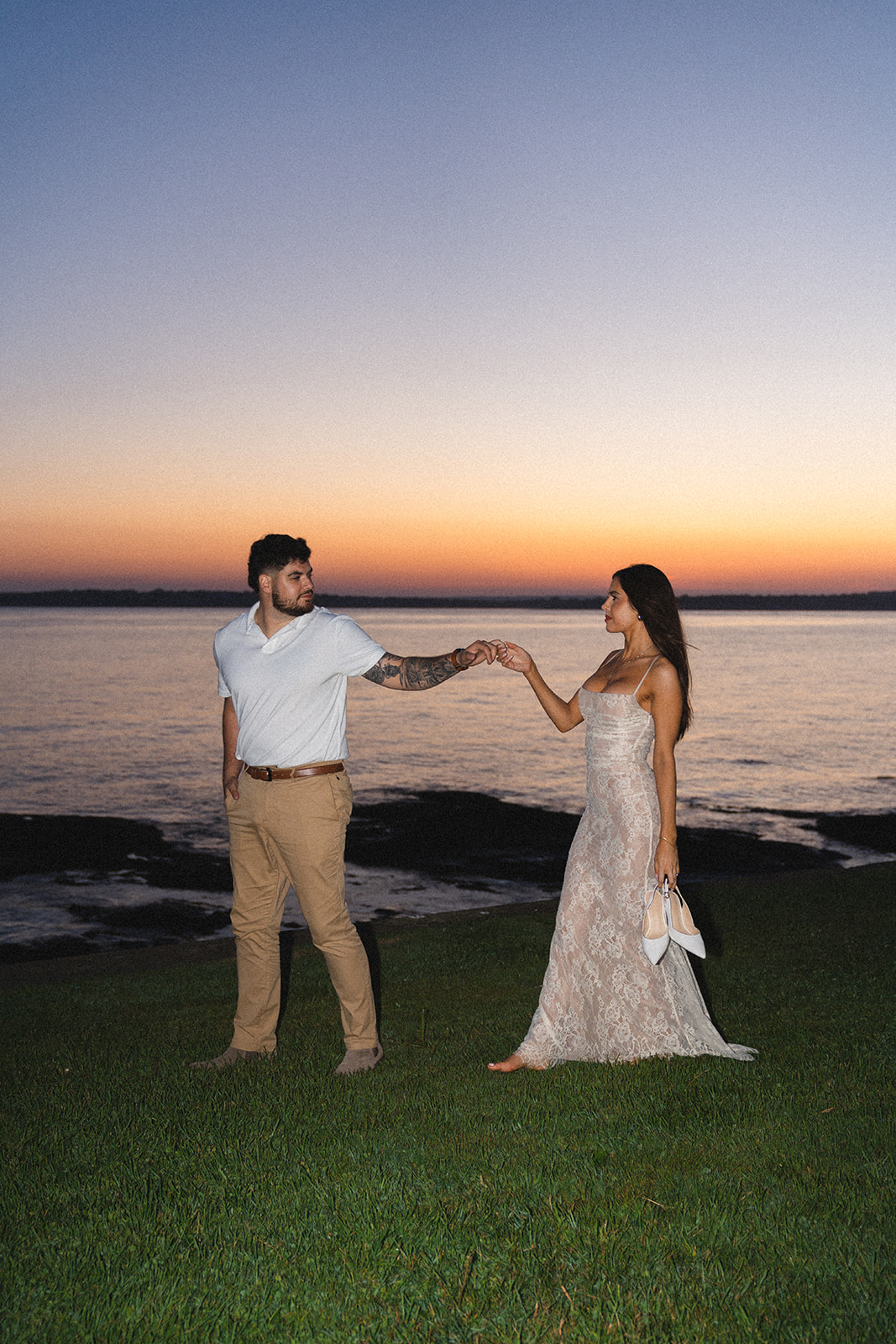 Newly engaged couple dancing during sunset in Newport RI