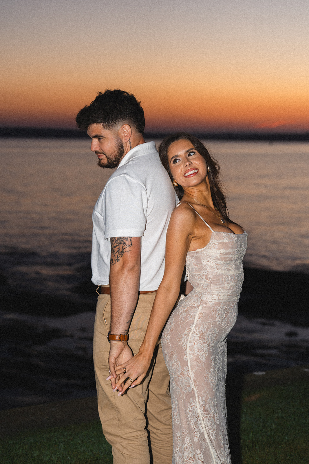 Newly engaged couple posing during sunset at Newport RI