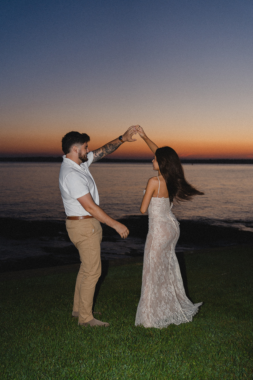 Newly engaged couple dancing during sunset at Newport RI