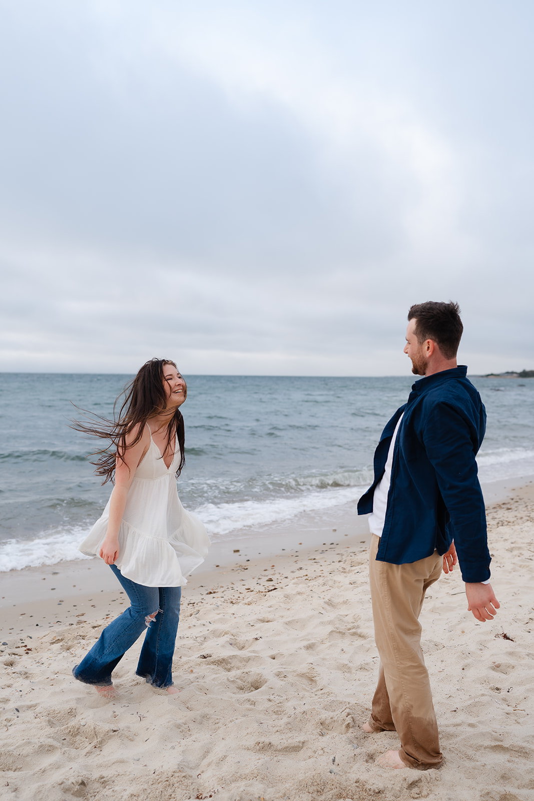 Engaged couple dancing on the beach for their Cape Cod engagement session