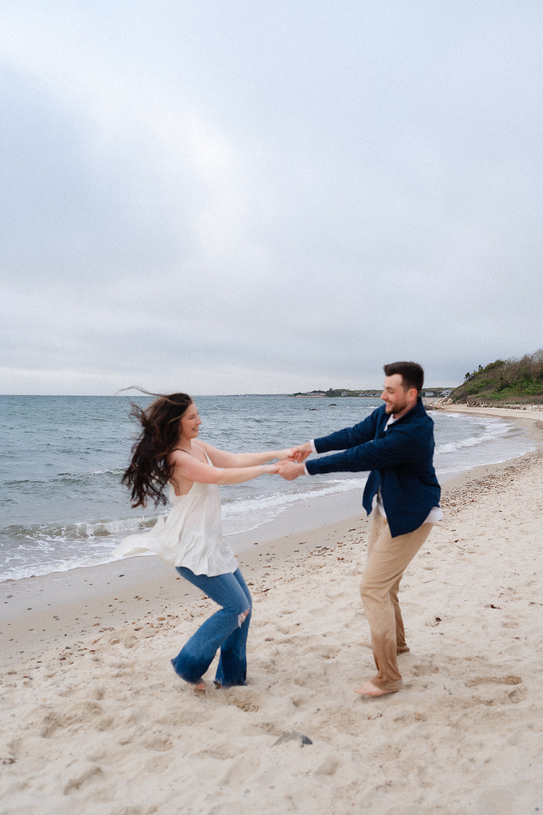 Engaged couple dancing on the beach at Cape Code