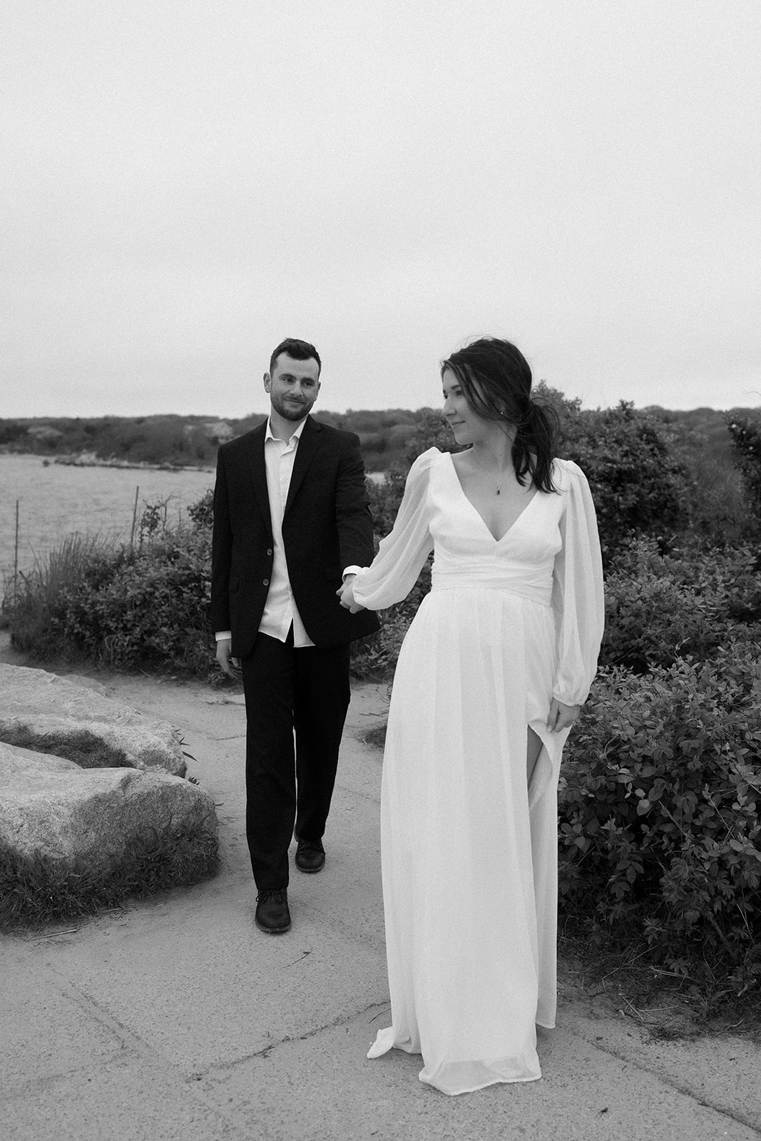 Black and white photo of engaged couple walking on the streets at The knob