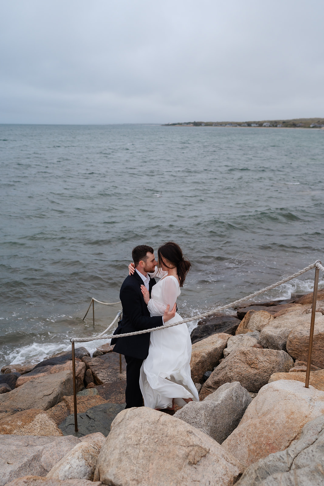 Engaged couple holding one another at The Knob at Cape Cod for their Cape cod engagement session