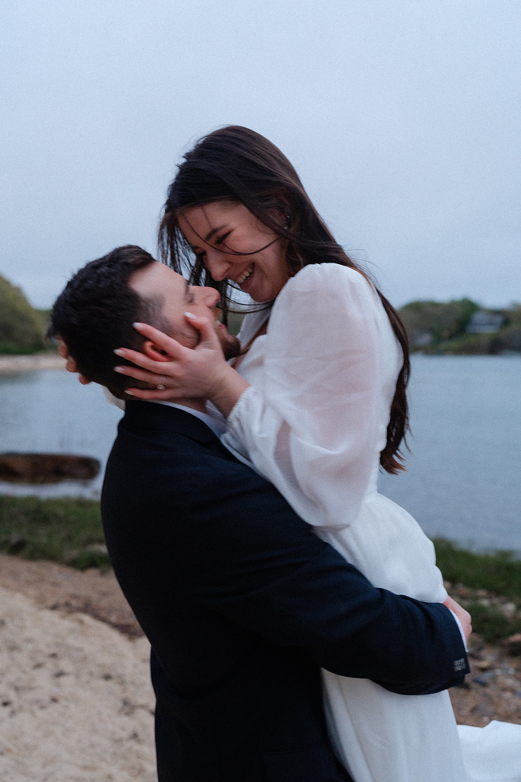 Engaged couple soaking wet holding one another during their Cape Cod engagement