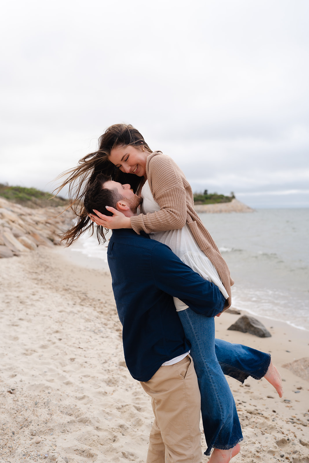 Engaged couple dancing on the beach during their Cape Cod engagement session