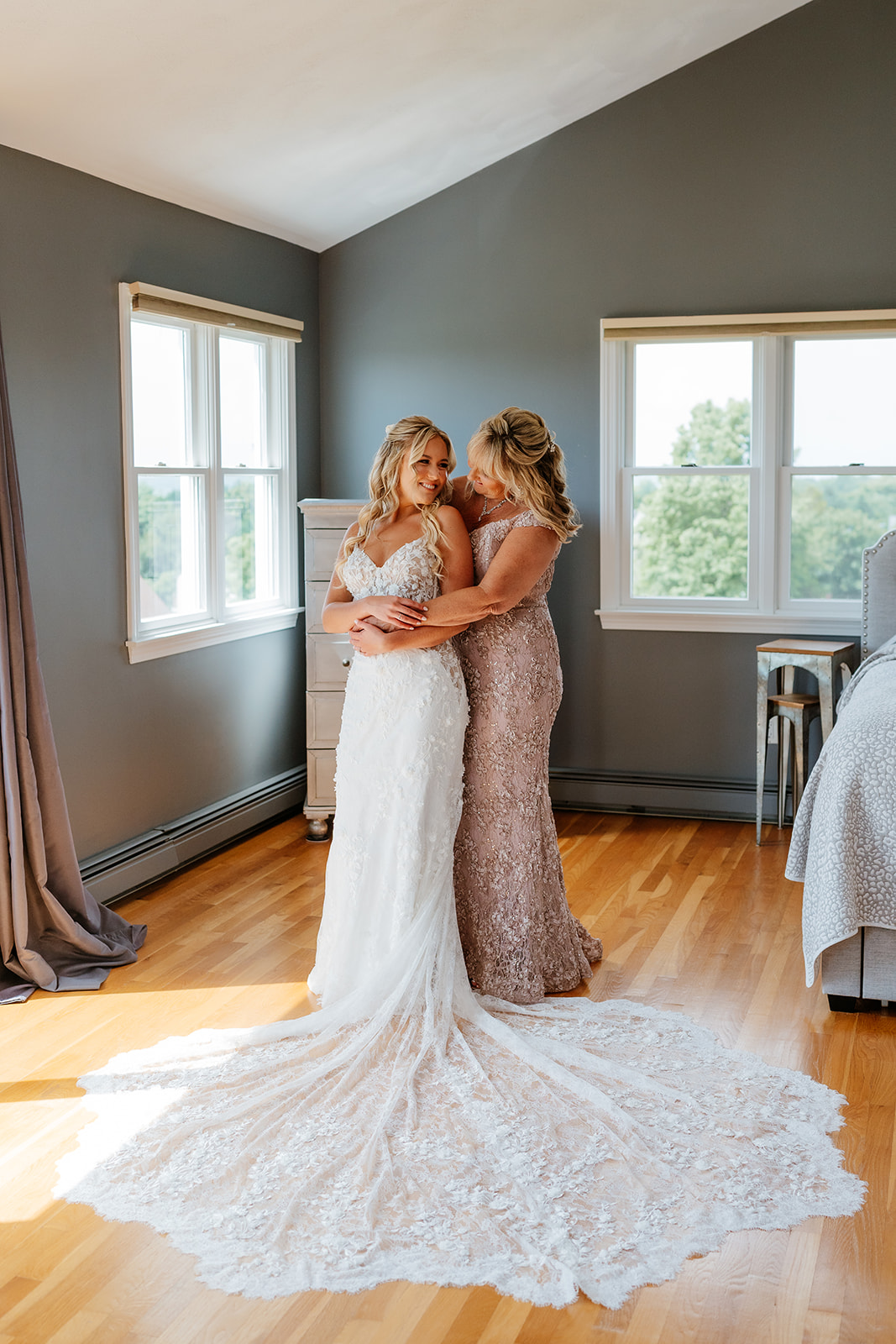 bride and mother of the bride hugging for a candid photo