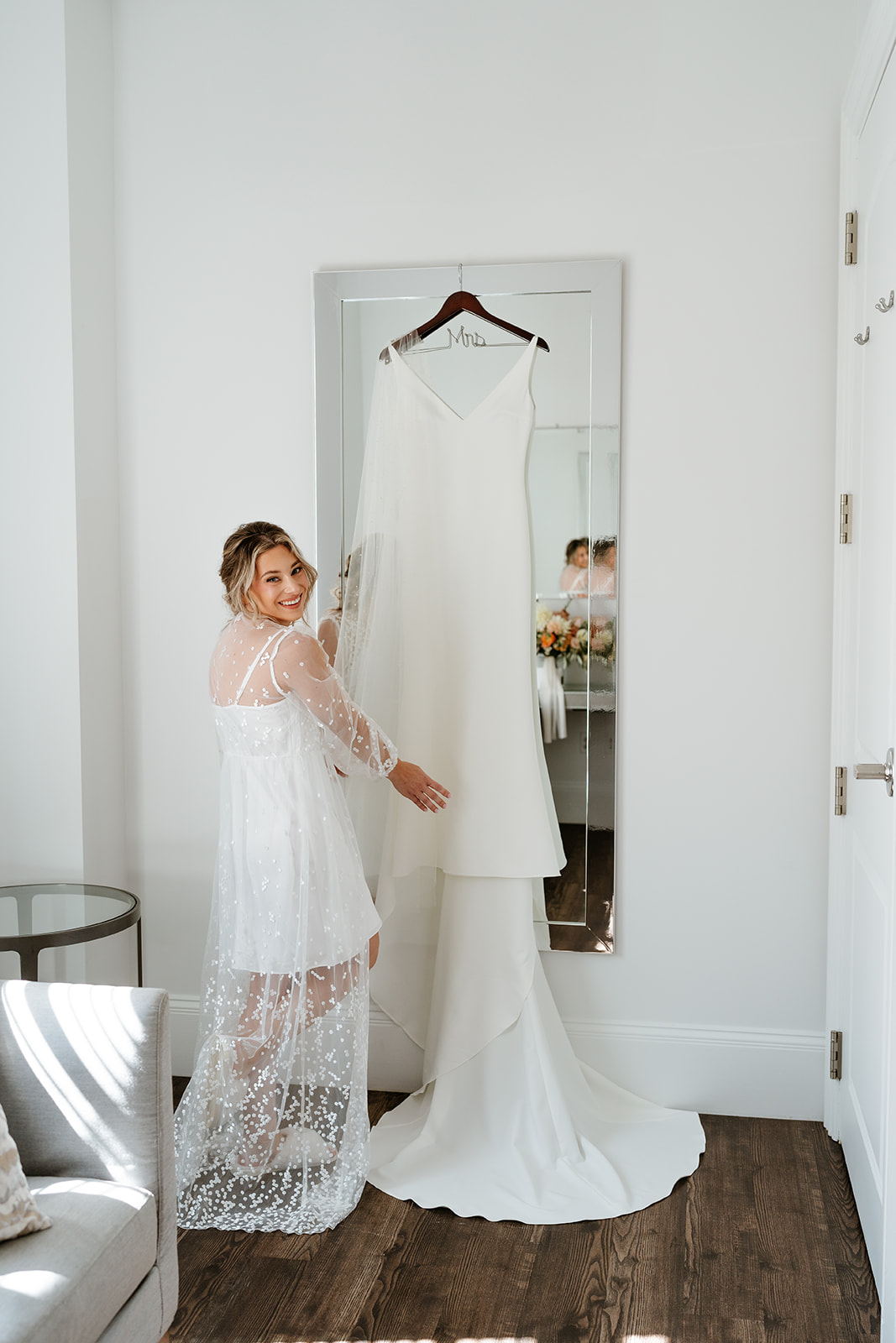 bride wearing her bridal get ready outfit showing off her wedding dress