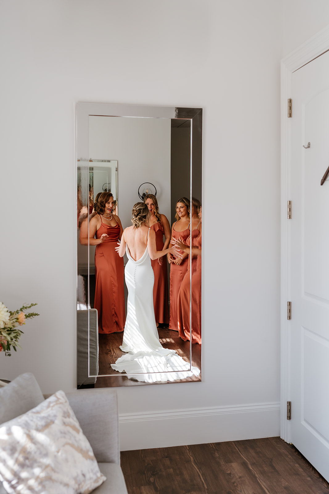 a mirror candid photo of the bride and the bridesmaids