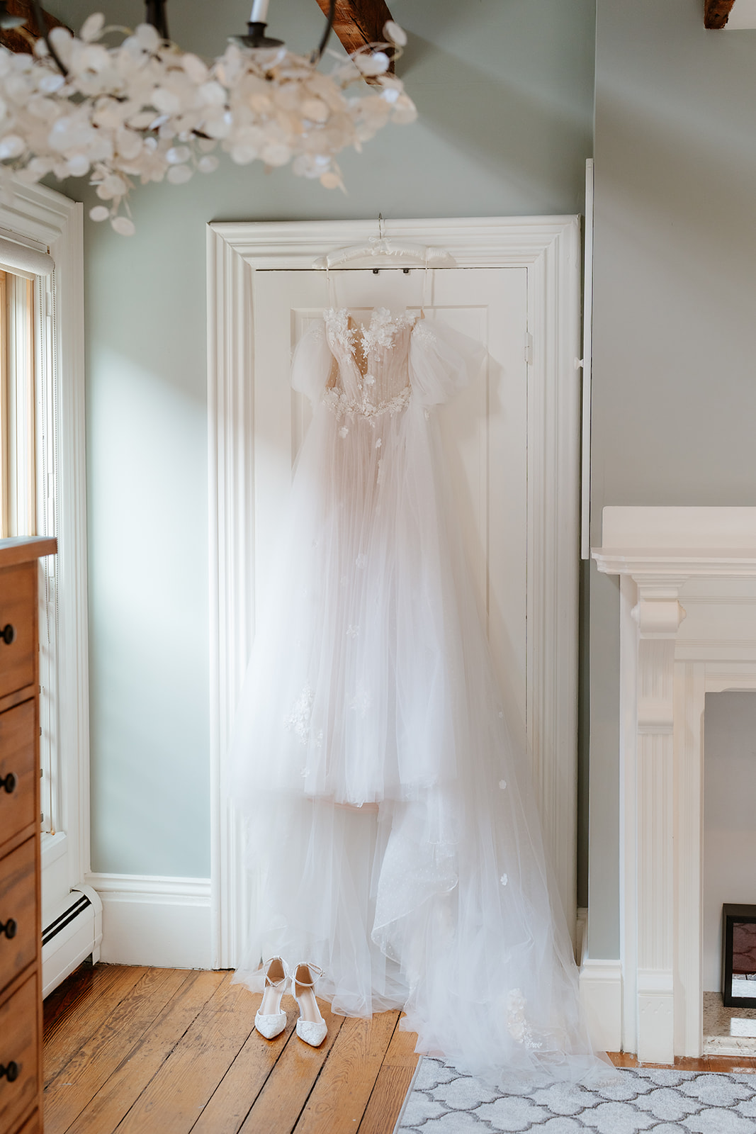 wedding dress hanging against the door at beautiful airbnb 