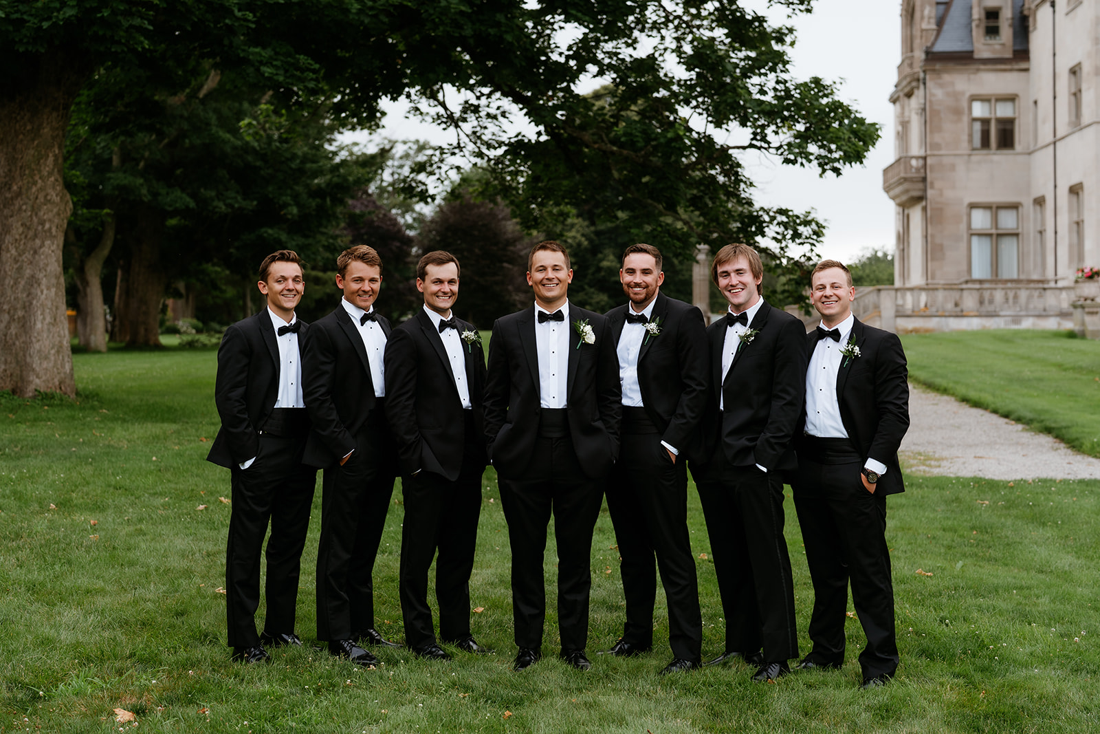 groom and his groomsmen smiling for a portrait photo