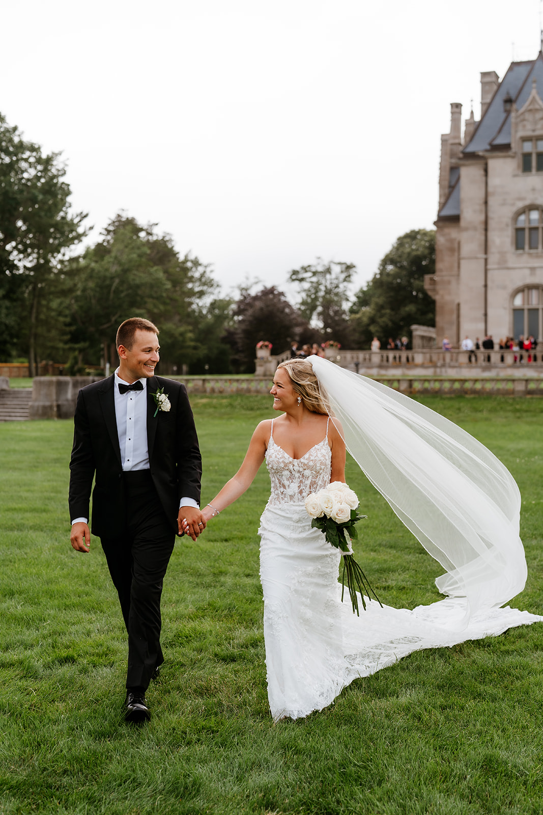 bride and groom loving glances walking holding hands at Ochre Court 