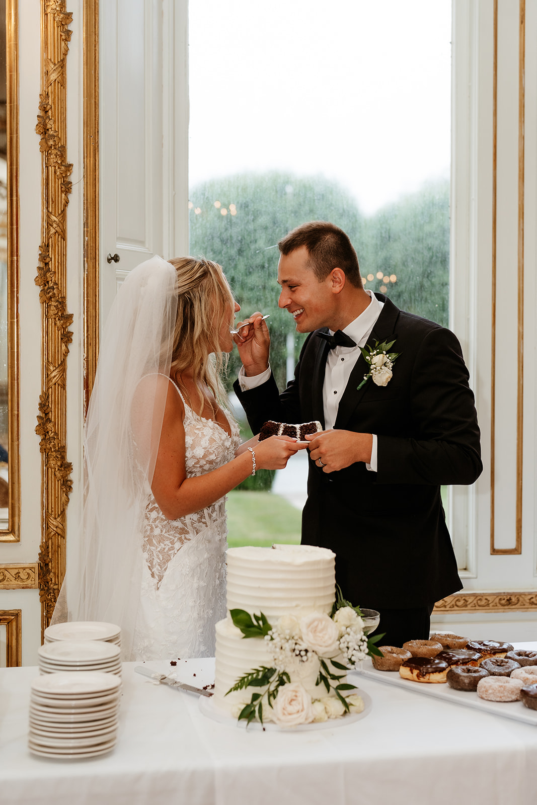 bride and groom candid photo during wedding cake cutting 