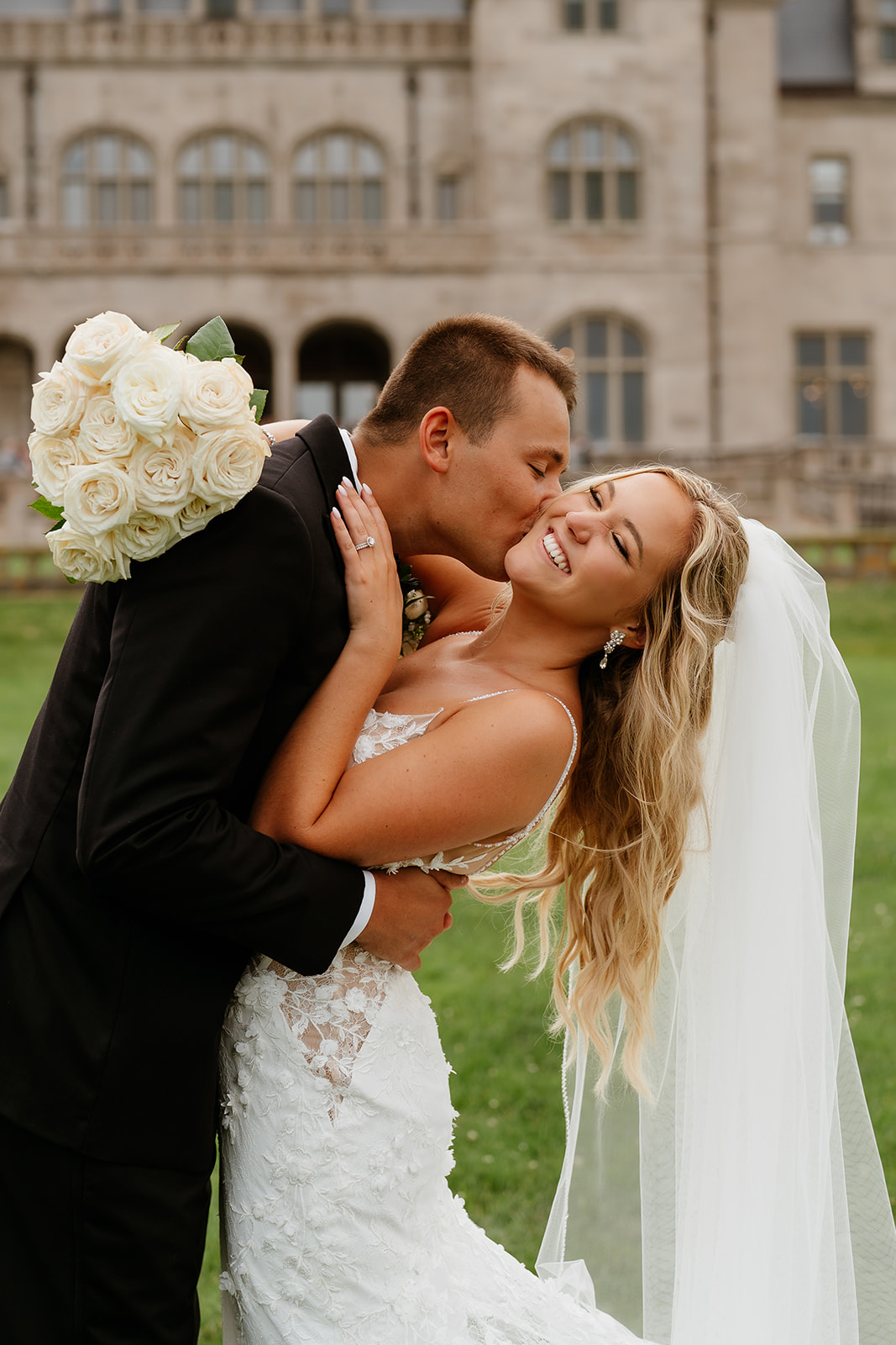 groom kissing the cheek of the bride for a romantic wedding portrait 