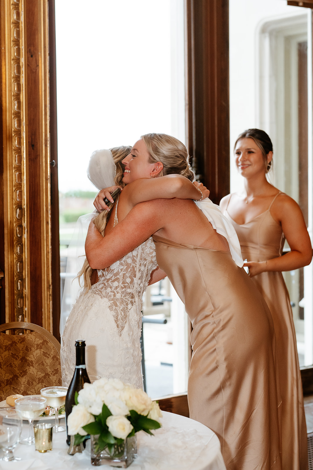 bride hugging one of her family member during wedding reception