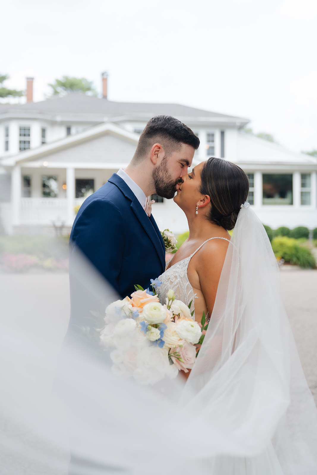 wedding portrait of bride and groom kissing 