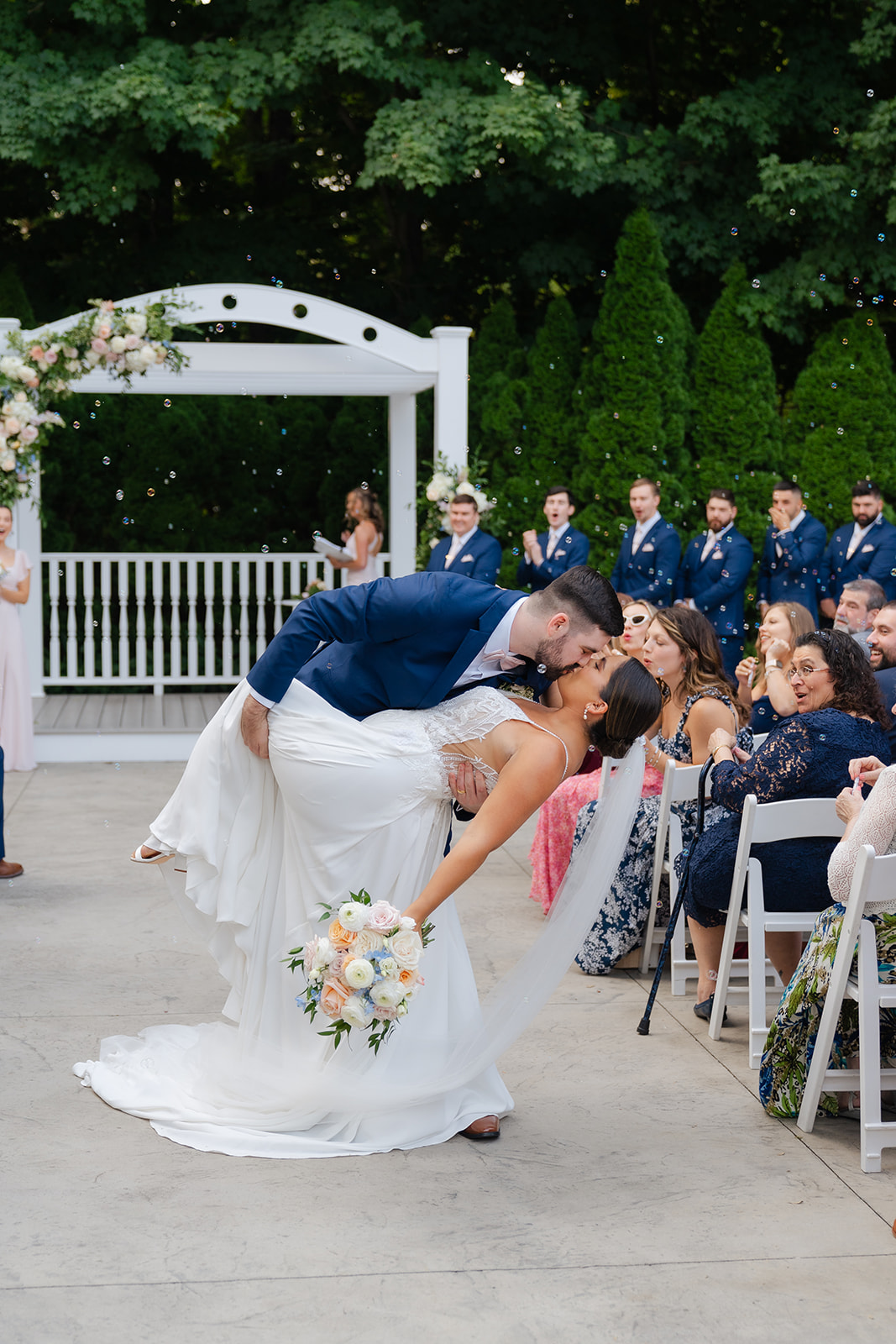 first kiss of bride and groom in wedding ceremony