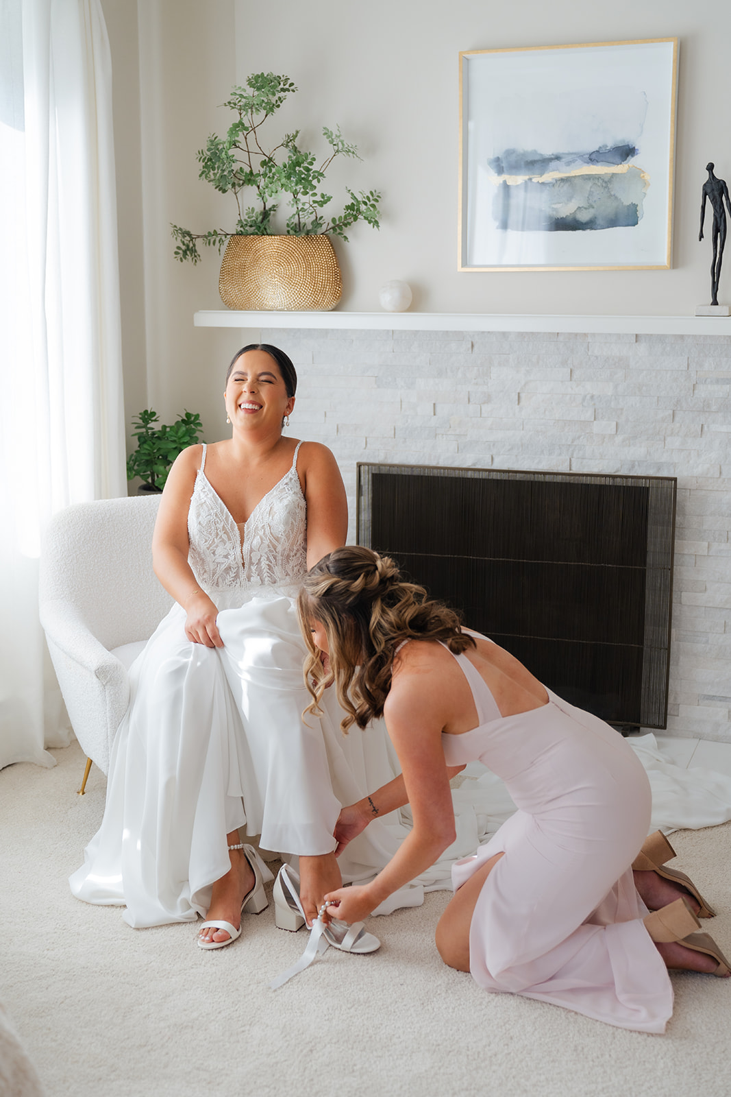 candid gettign ready photo of the bride and bridesmaid