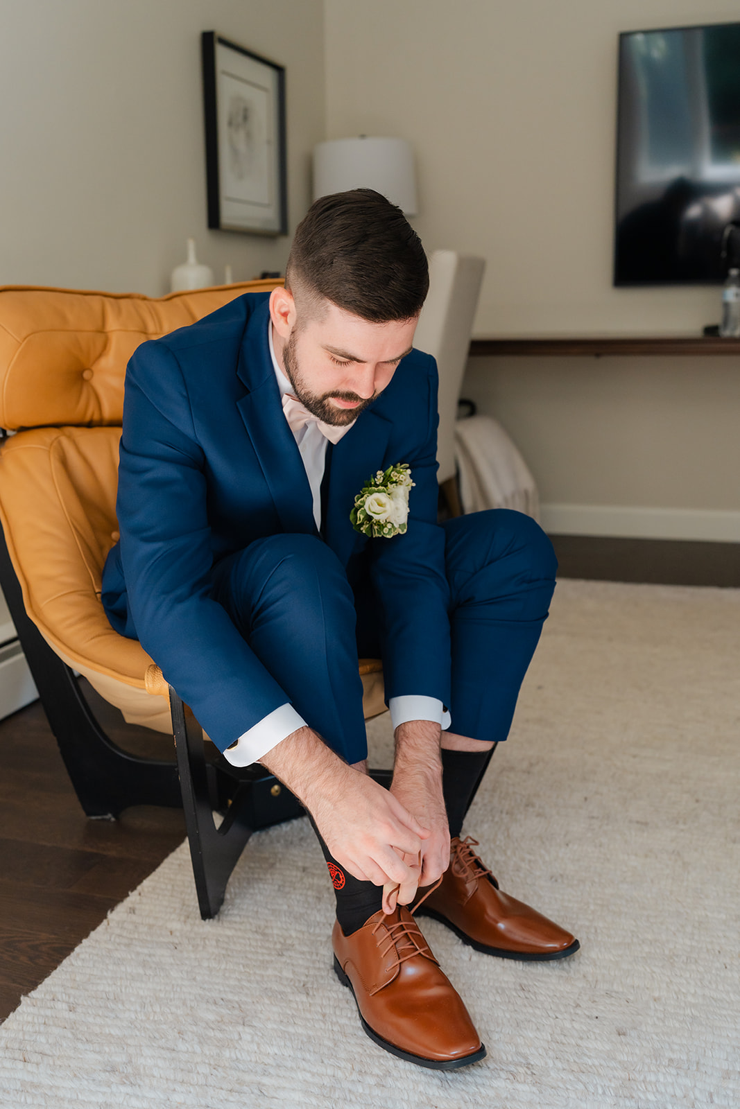 groom getting ready tying his shoes